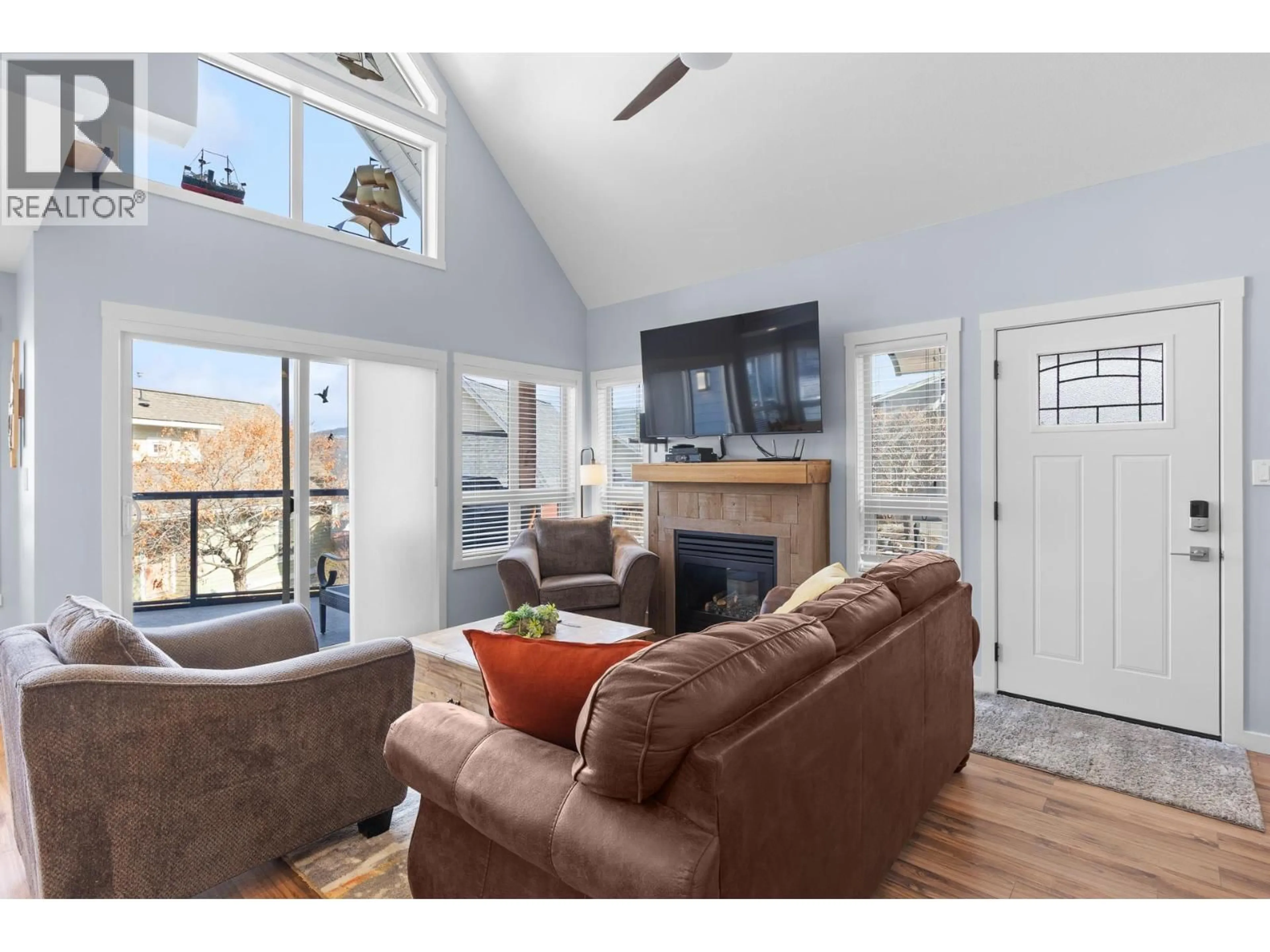 Living room with furniture, wood/laminate floor for 179 - 6844 SANTIAGO LOOP, Kelowna British Columbia V1Z3R8