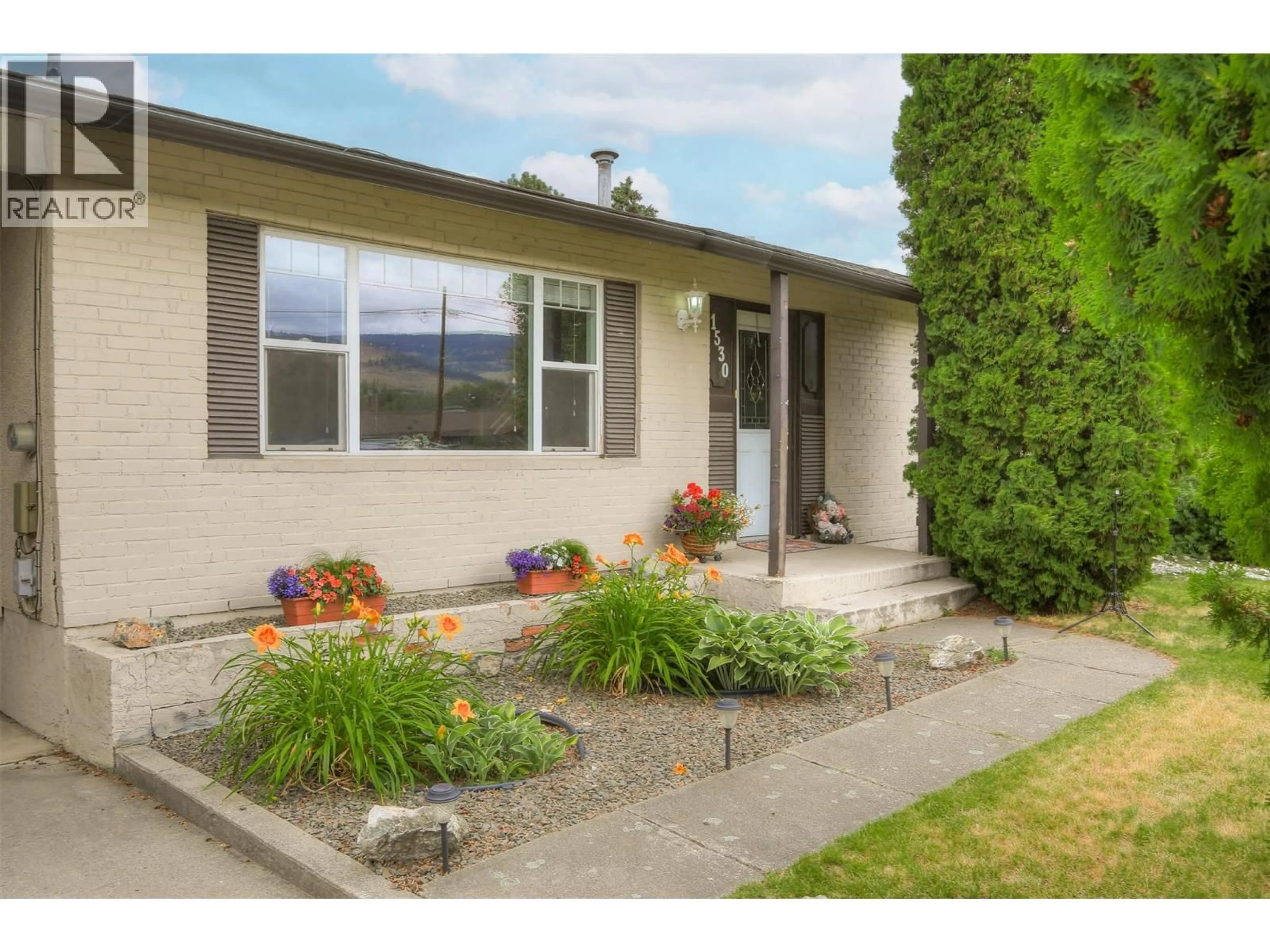 Home with vinyl exterior material, street for 1530 FRIESEN ROAD, Kelowna British Columbia V1X4X6