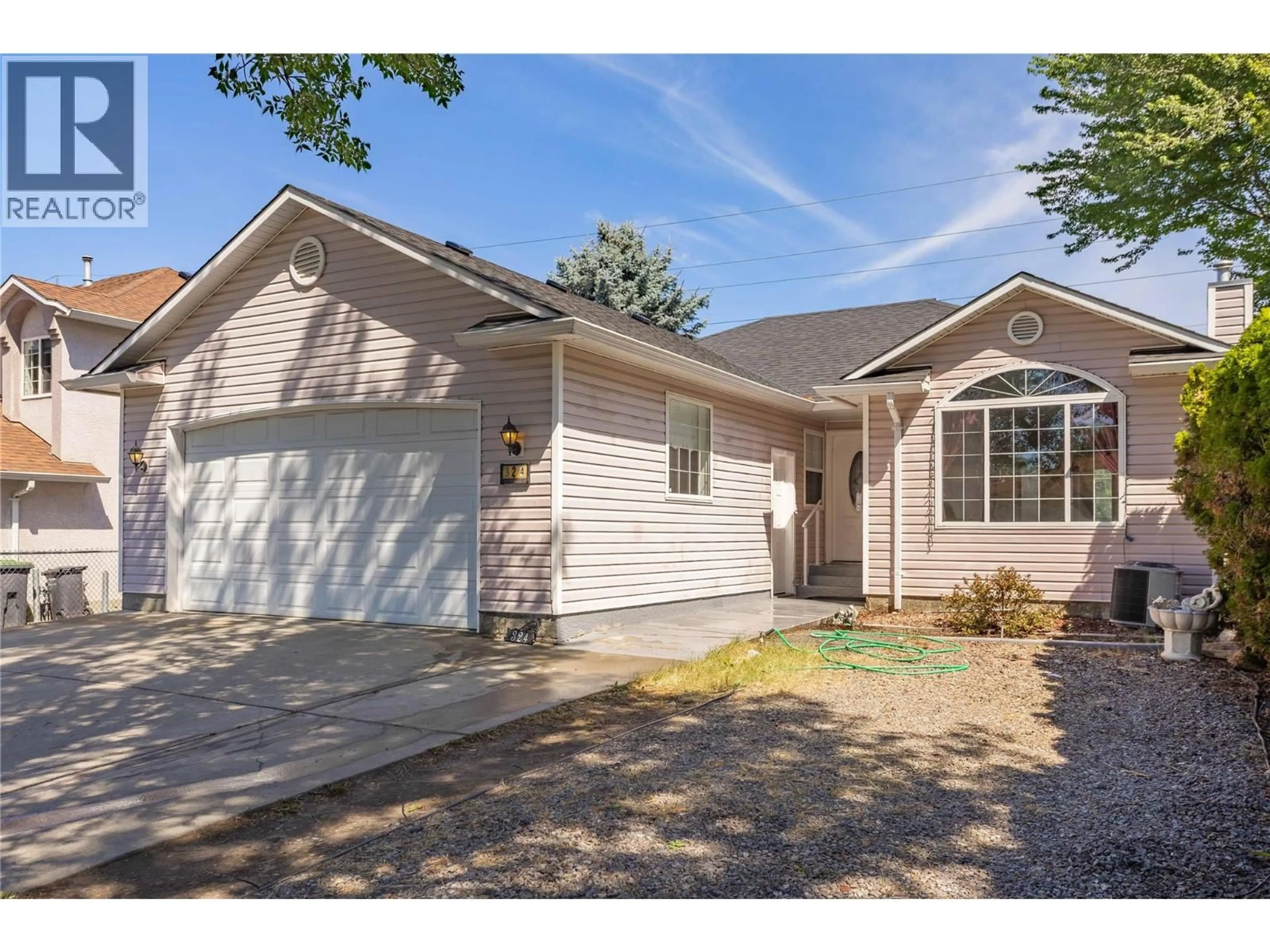 Home with vinyl exterior material, street for 324 KLASSEN ROAD, Kelowna British Columbia V1X7P2
