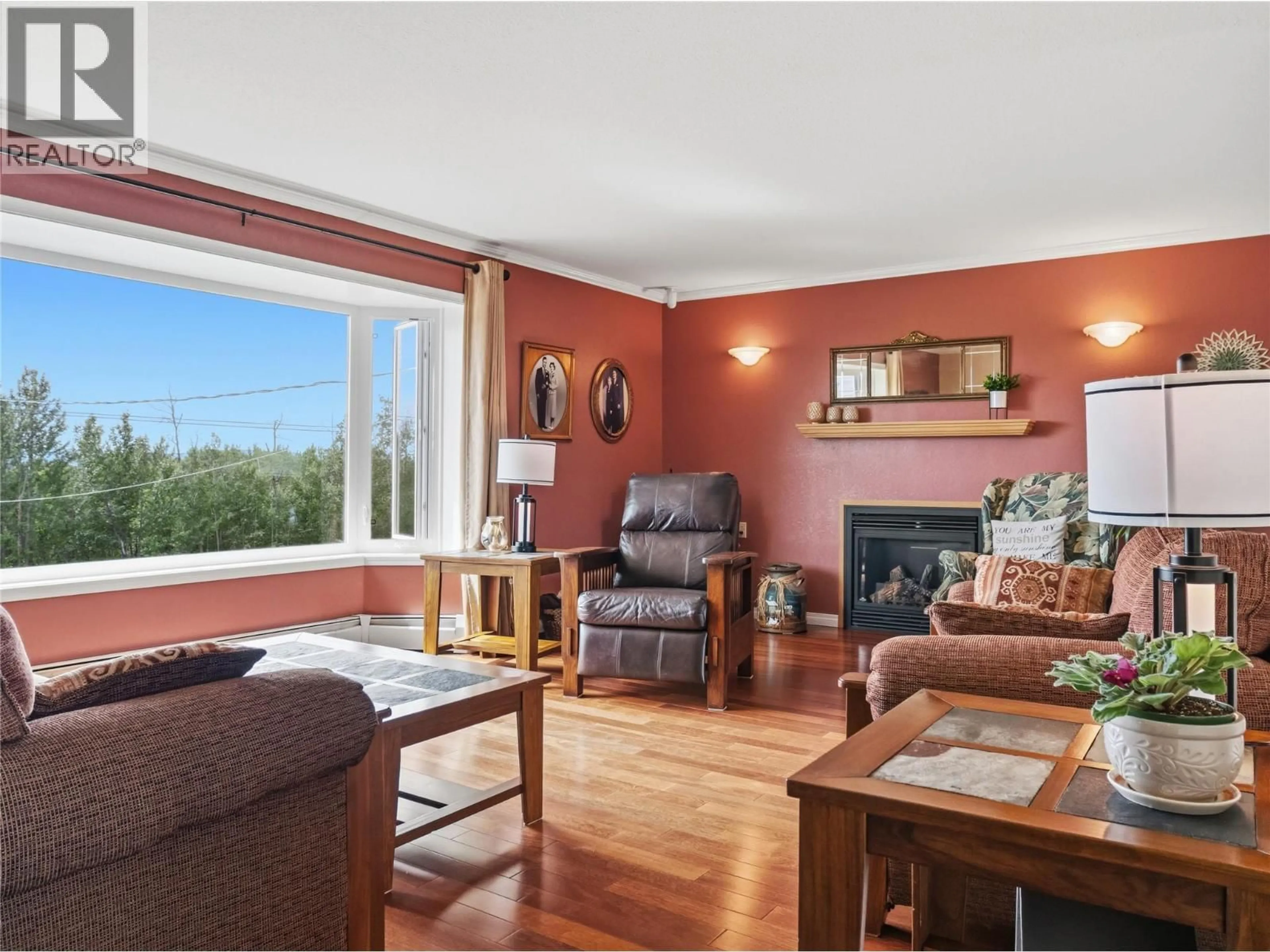 Living room with furniture, wood/laminate floor for 1110 210 ROAD, Dawson Creek British Columbia V1G4E8