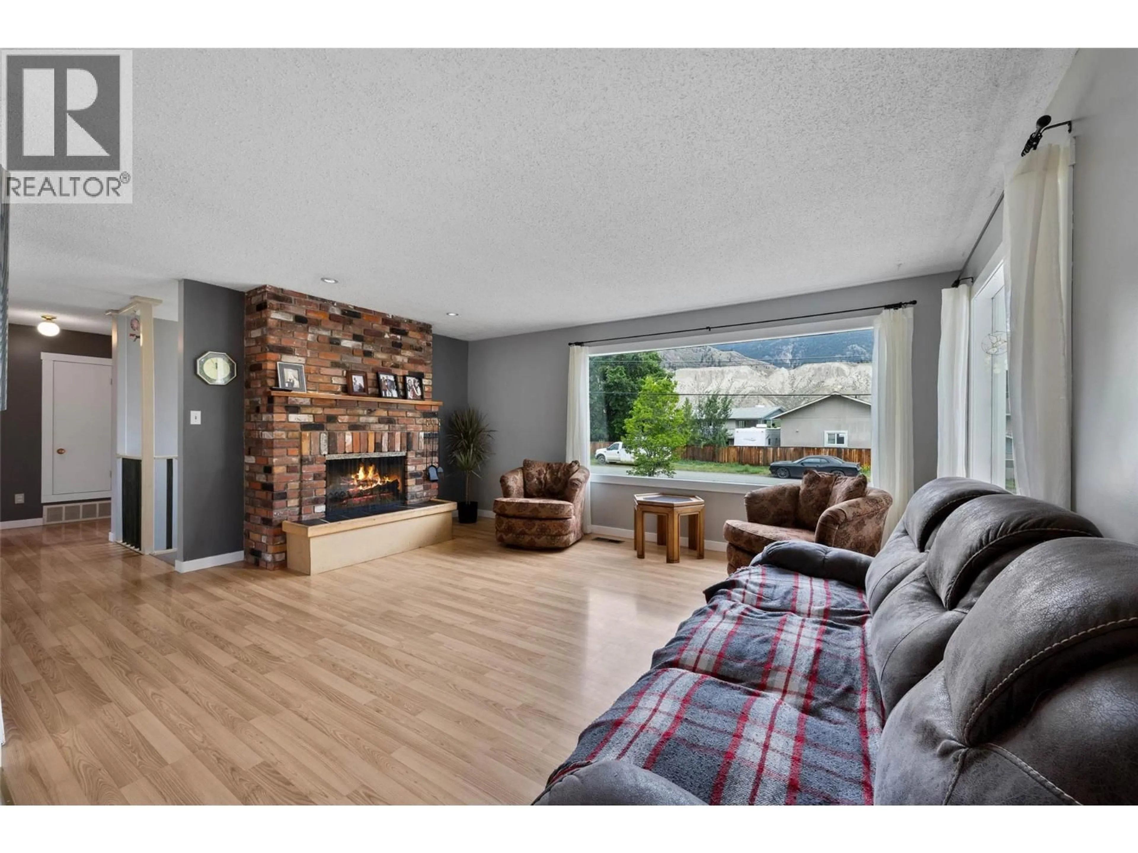 Living room with furniture, wood/laminate floor for 6685 BEAVER CRESCENT, Kamloops British Columbia V2C4B2