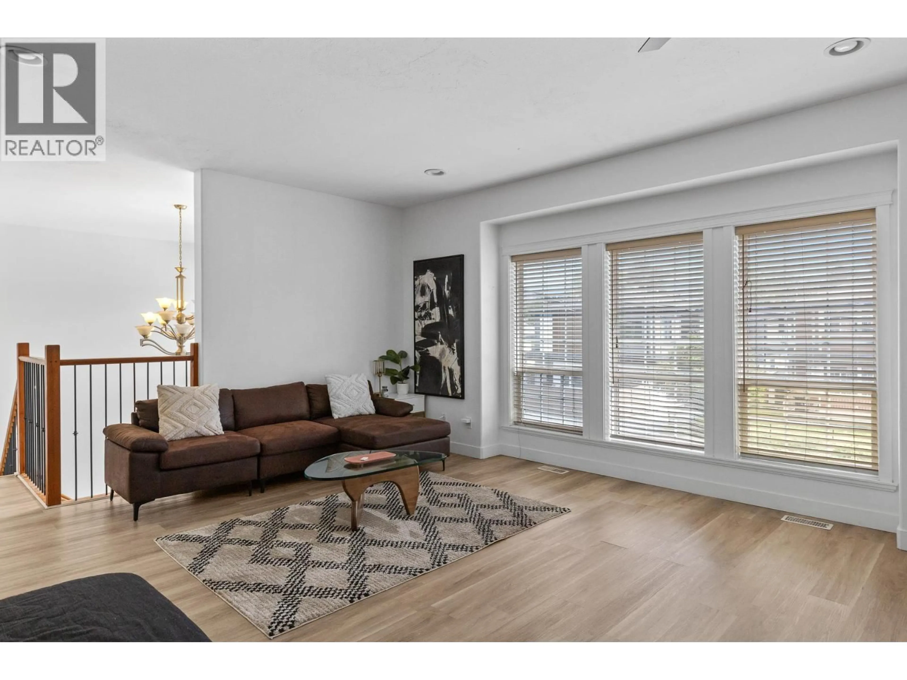 Living room with furniture, wood/laminate floor for 1374 MCINNES AVENUE, Kelowna British Columbia V1Y5V9
