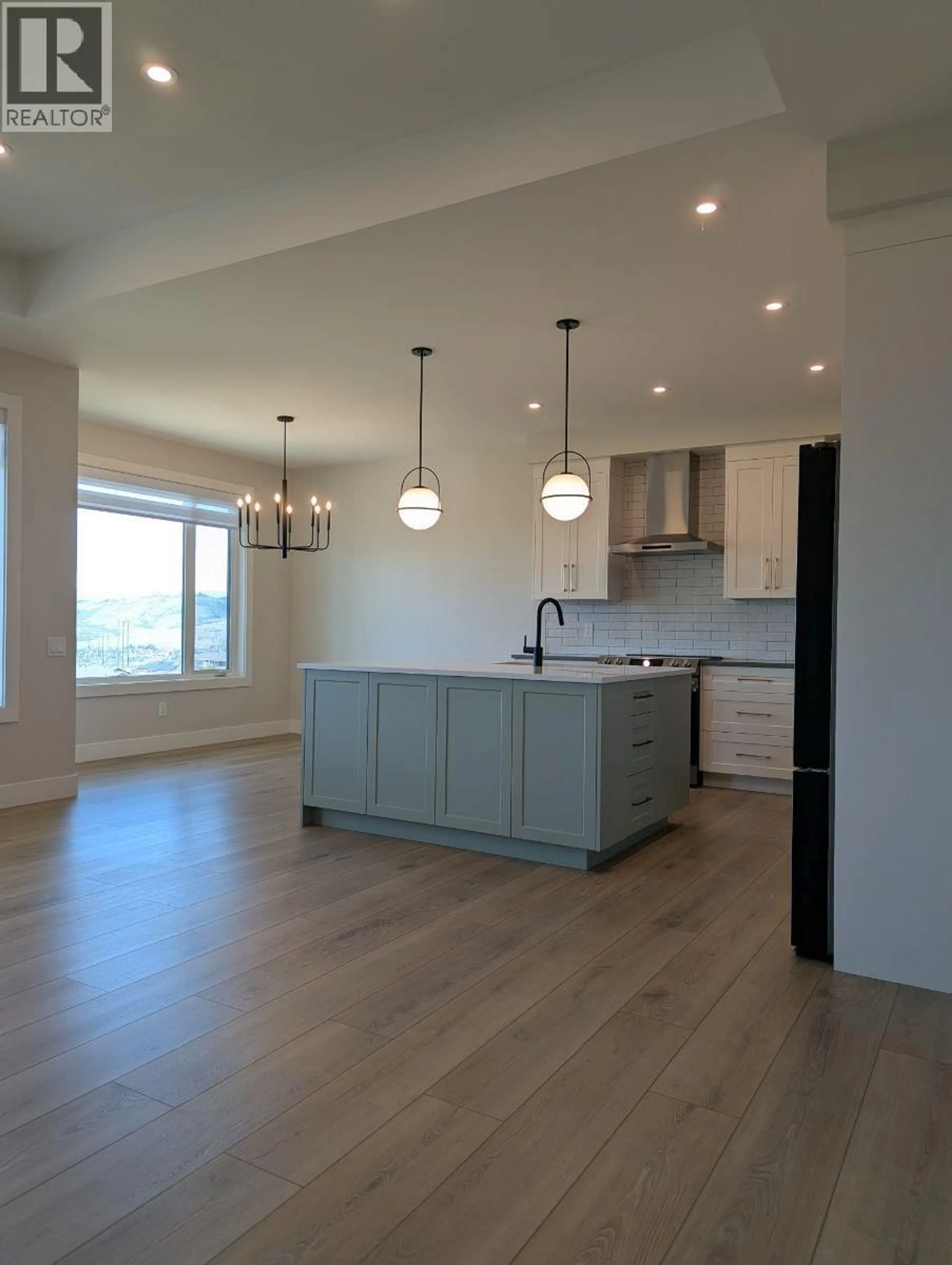Open concept kitchen, wood/laminate floor for 195 WHISTLER PLACE, Vernon British Columbia V1B2Y2