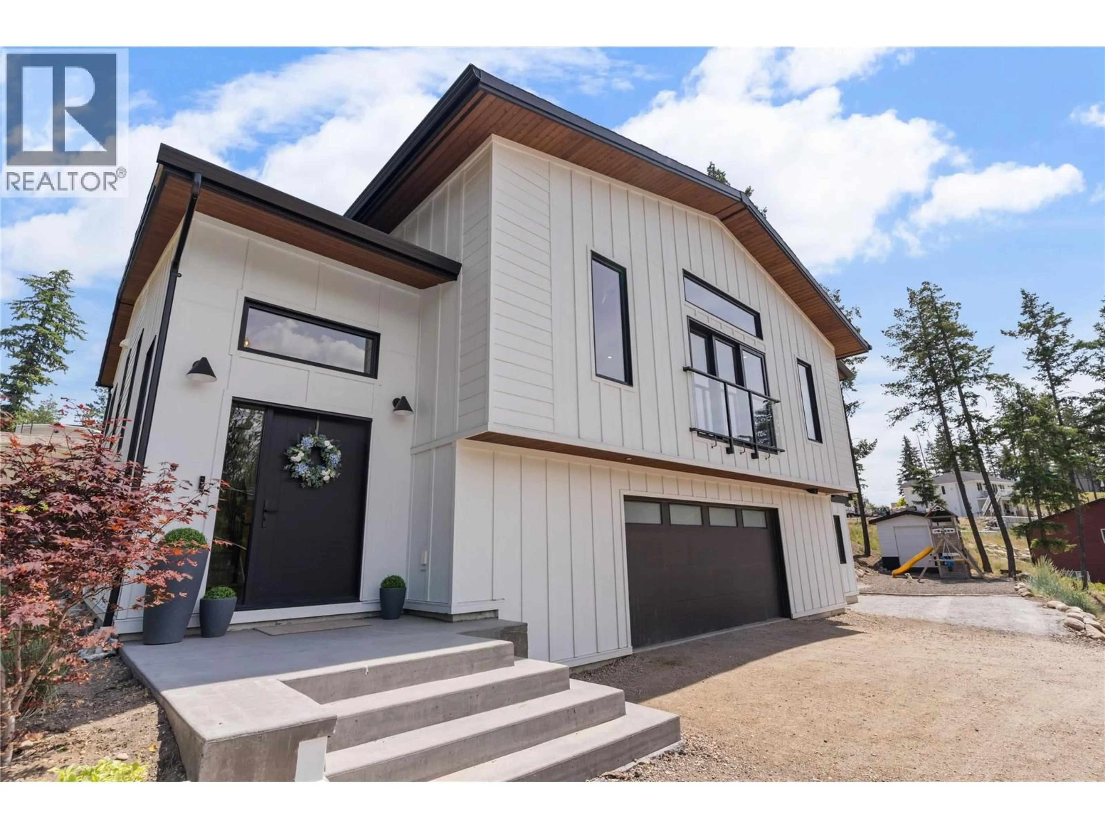 Home with vinyl exterior material, street for 7111 DUNWATERS ROAD, Kelowna British Columbia V1W3W6