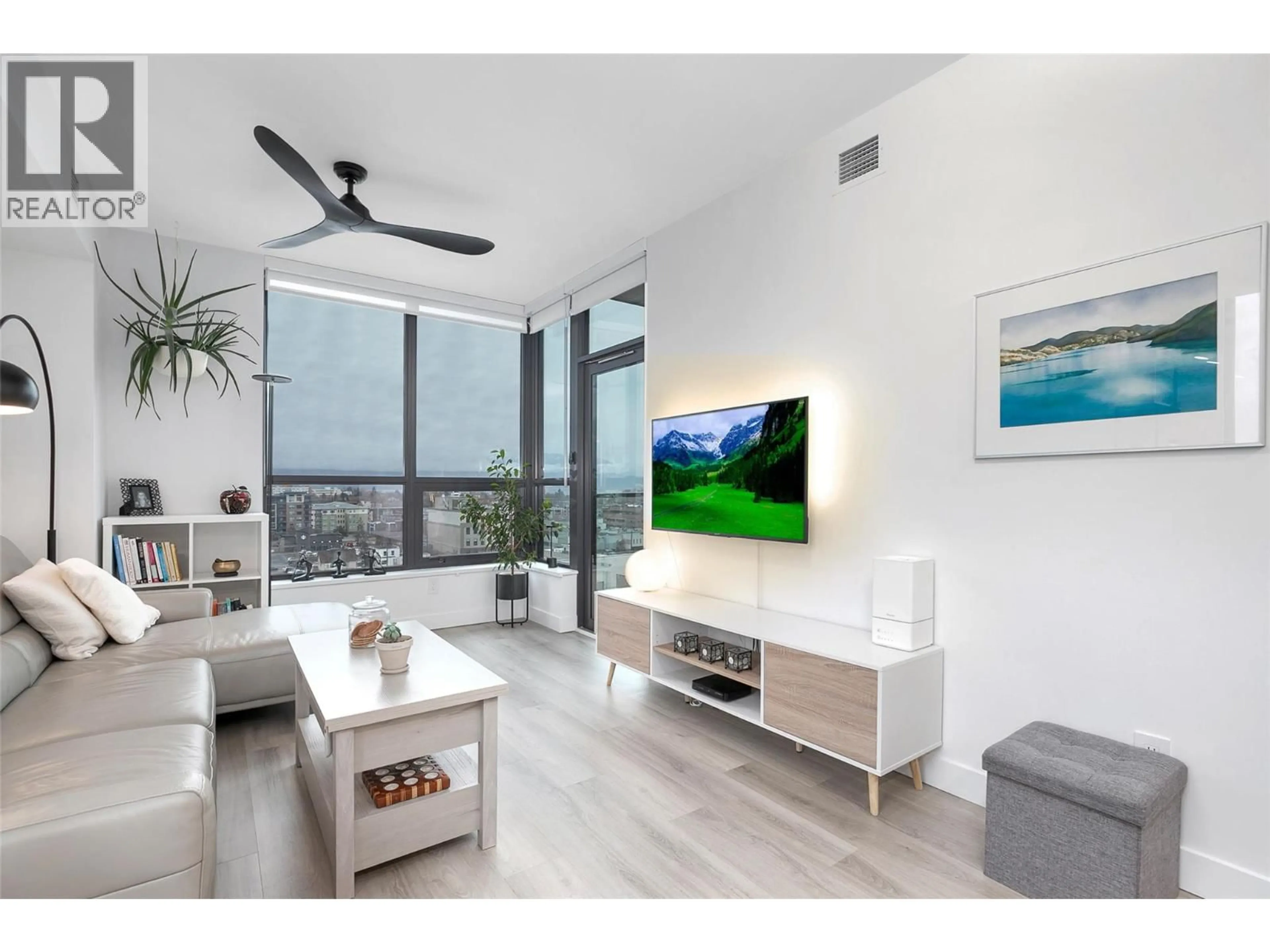 Living room with furniture, wood/laminate floor for 905 - 1488 BERTRAM STREET, Kelowna British Columbia V1Y0M6