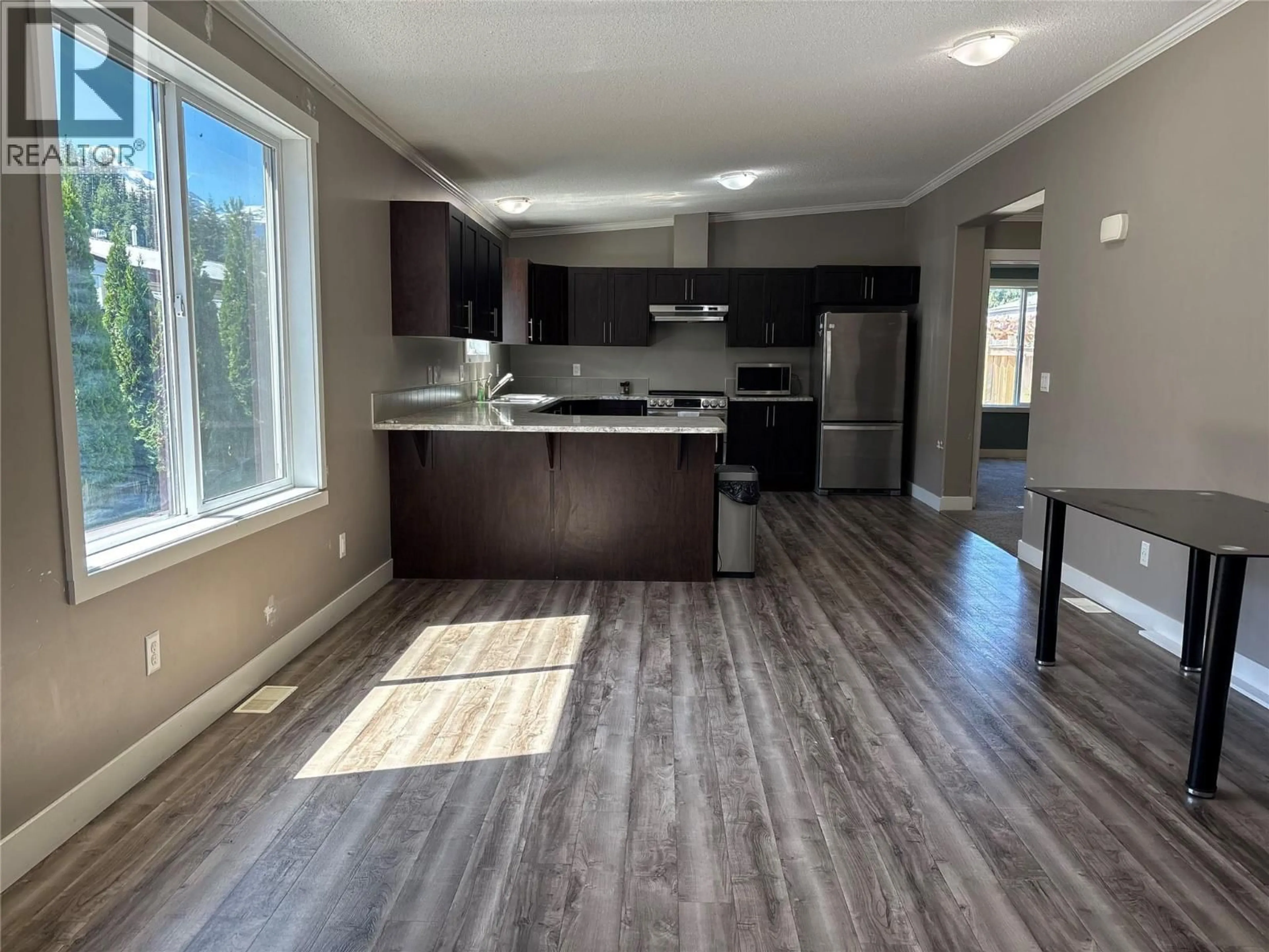 Open concept kitchen, wood/laminate floor for 66 JOHNSON WAY, Revelstoke British Columbia V0E2S1