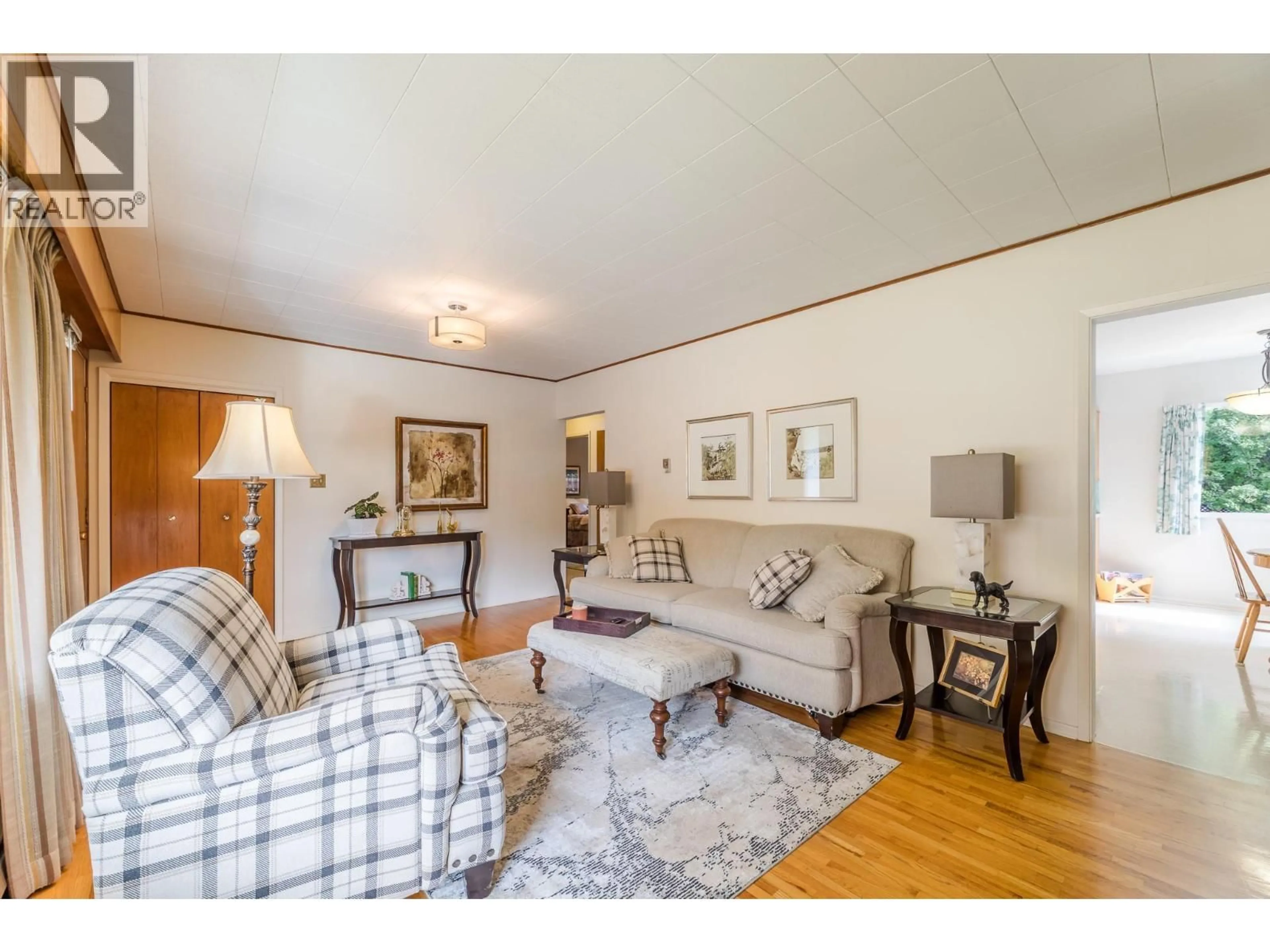 Living room with furniture, wood/laminate floor for 14001 AMM AVENUE, Summerland British Columbia V0H1Z0