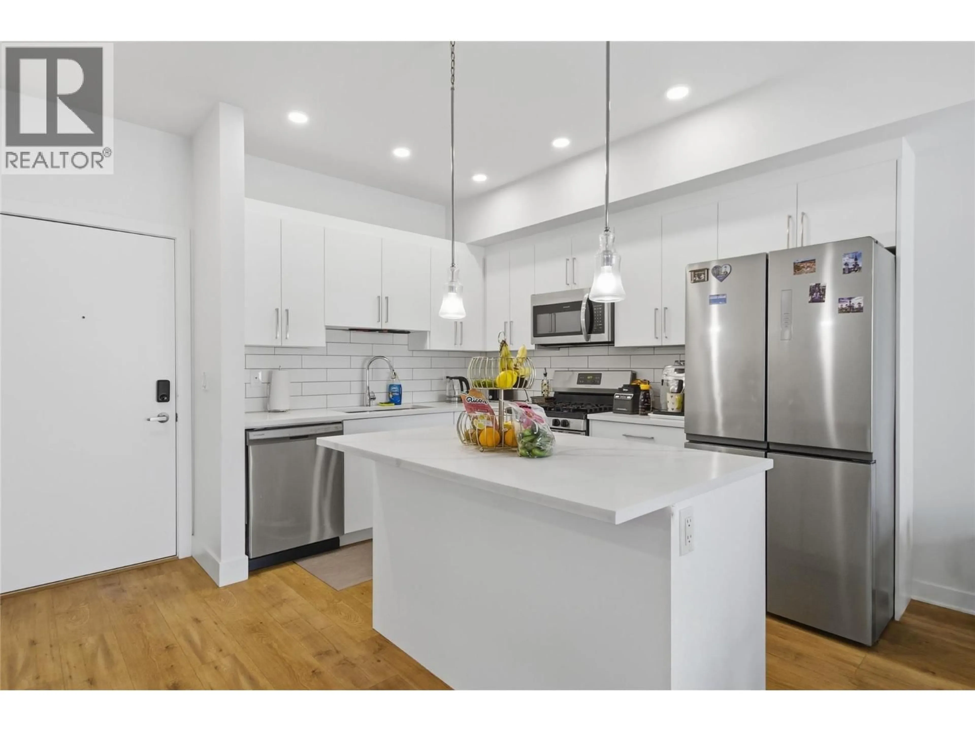 Open concept kitchen, wood/laminate floor for 216 - 2046 ROBSON PLACE, Kamloops British Columbia V2E0A5