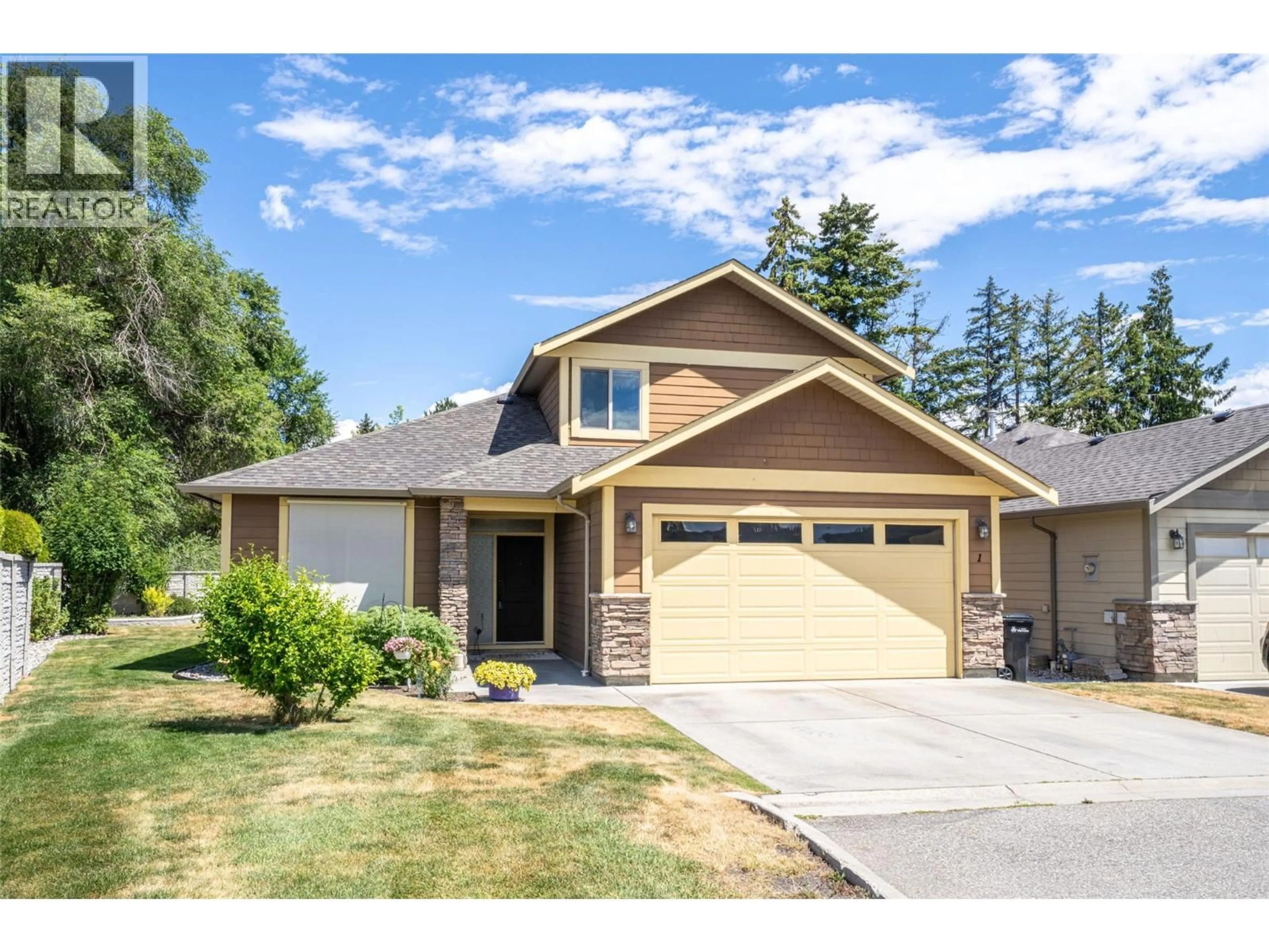 Home with vinyl exterior material, street for 1 - 6450 OKANAGAN LANDING ROAD, Vernon British Columbia V1H2H5