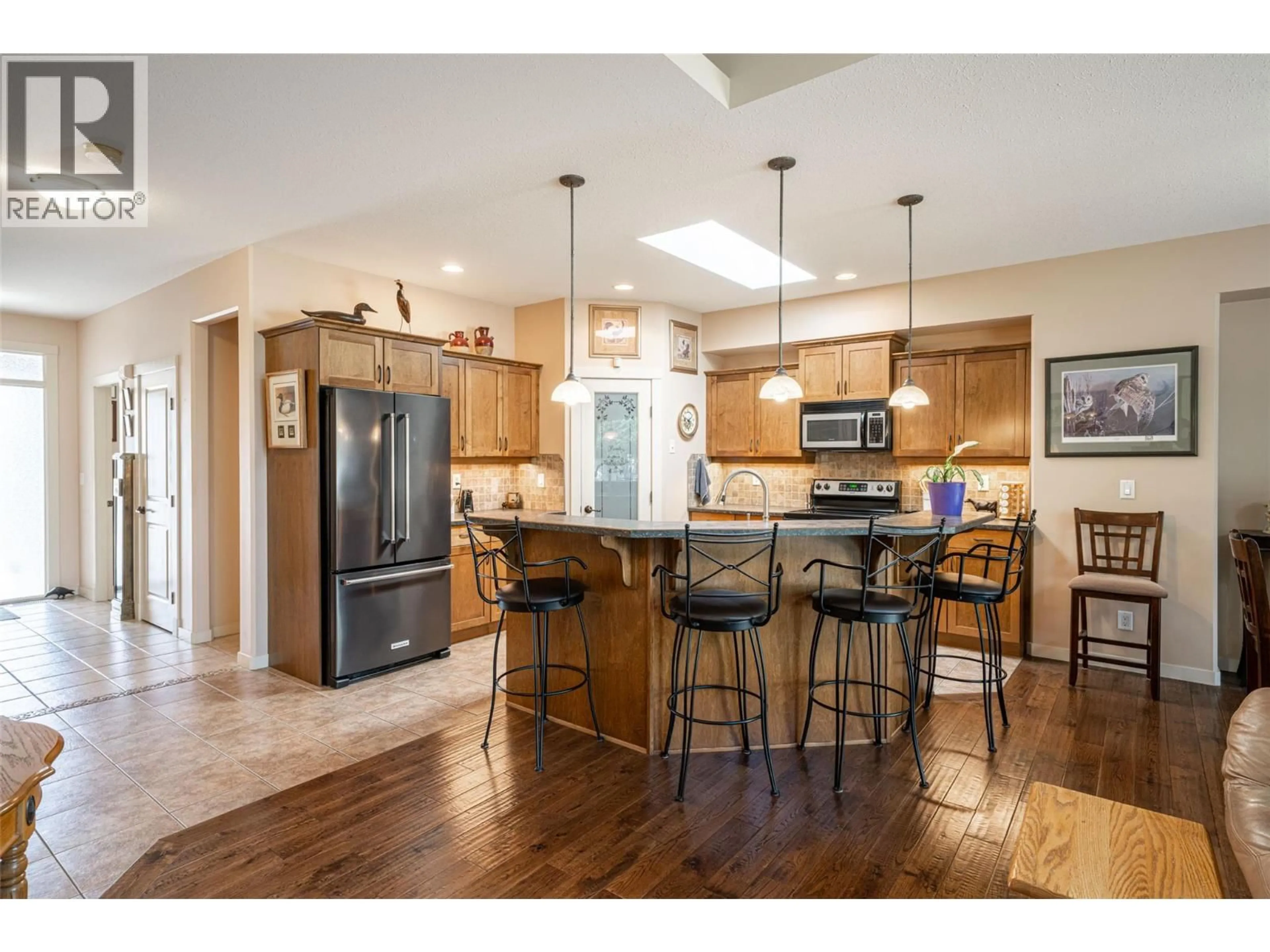 Open concept kitchen, wood/laminate floor for 1 - 6450 OKANAGAN LANDING ROAD, Vernon British Columbia V1H2H5