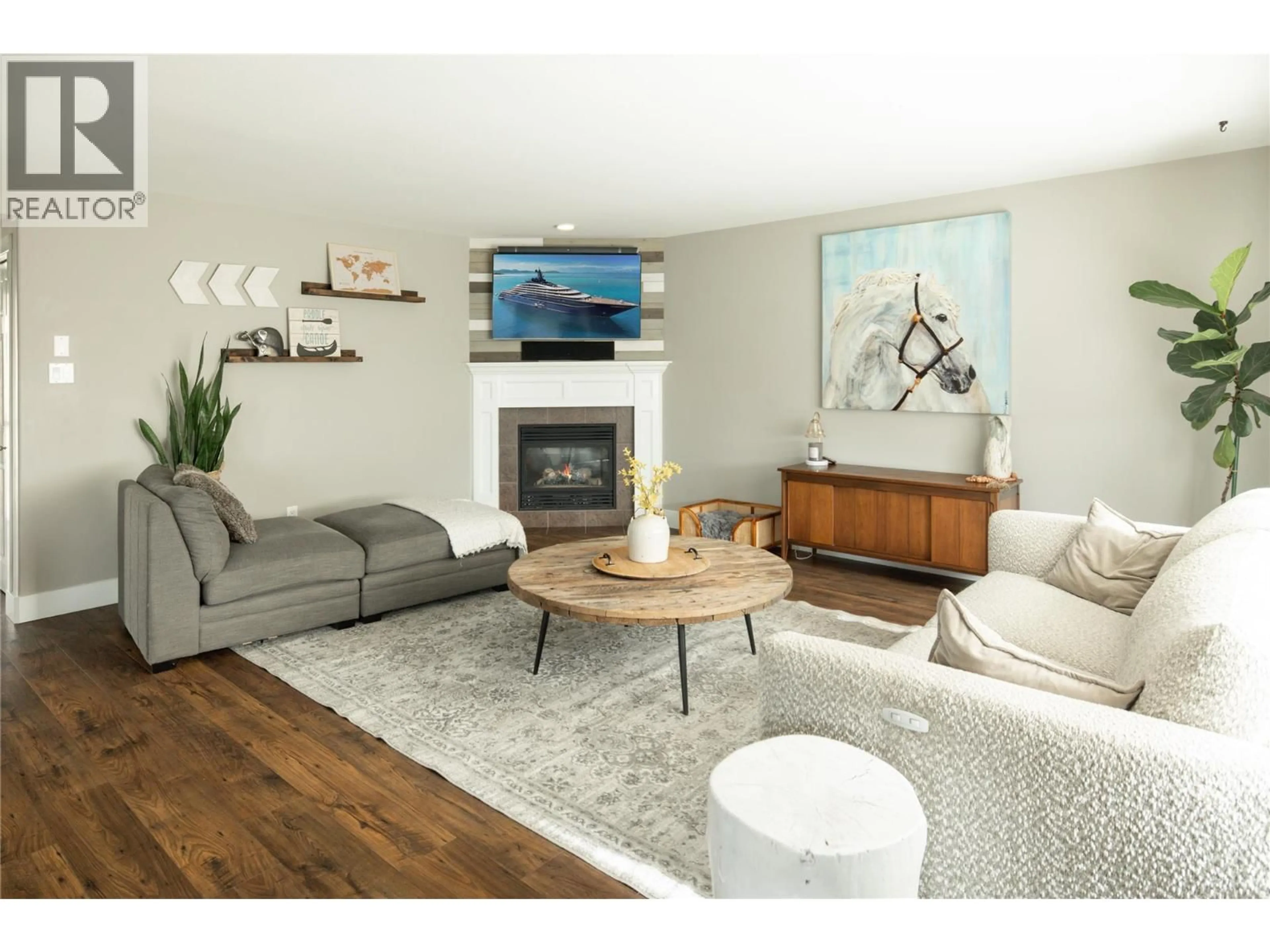 Living room with furniture, wood/laminate floor for 10460 SHERMAN DRIVE, Lake Country British Columbia V4V2N2