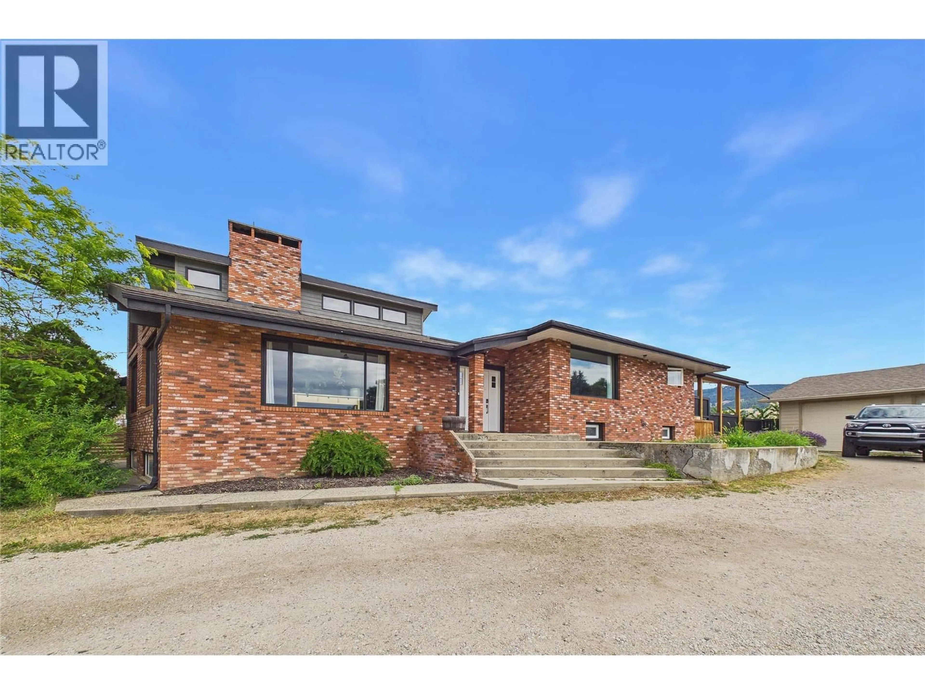 Home with brick exterior material, street for 10371 OKANAGAN CENTRE ROAD EAST, Lake Country British Columbia V4V1K9