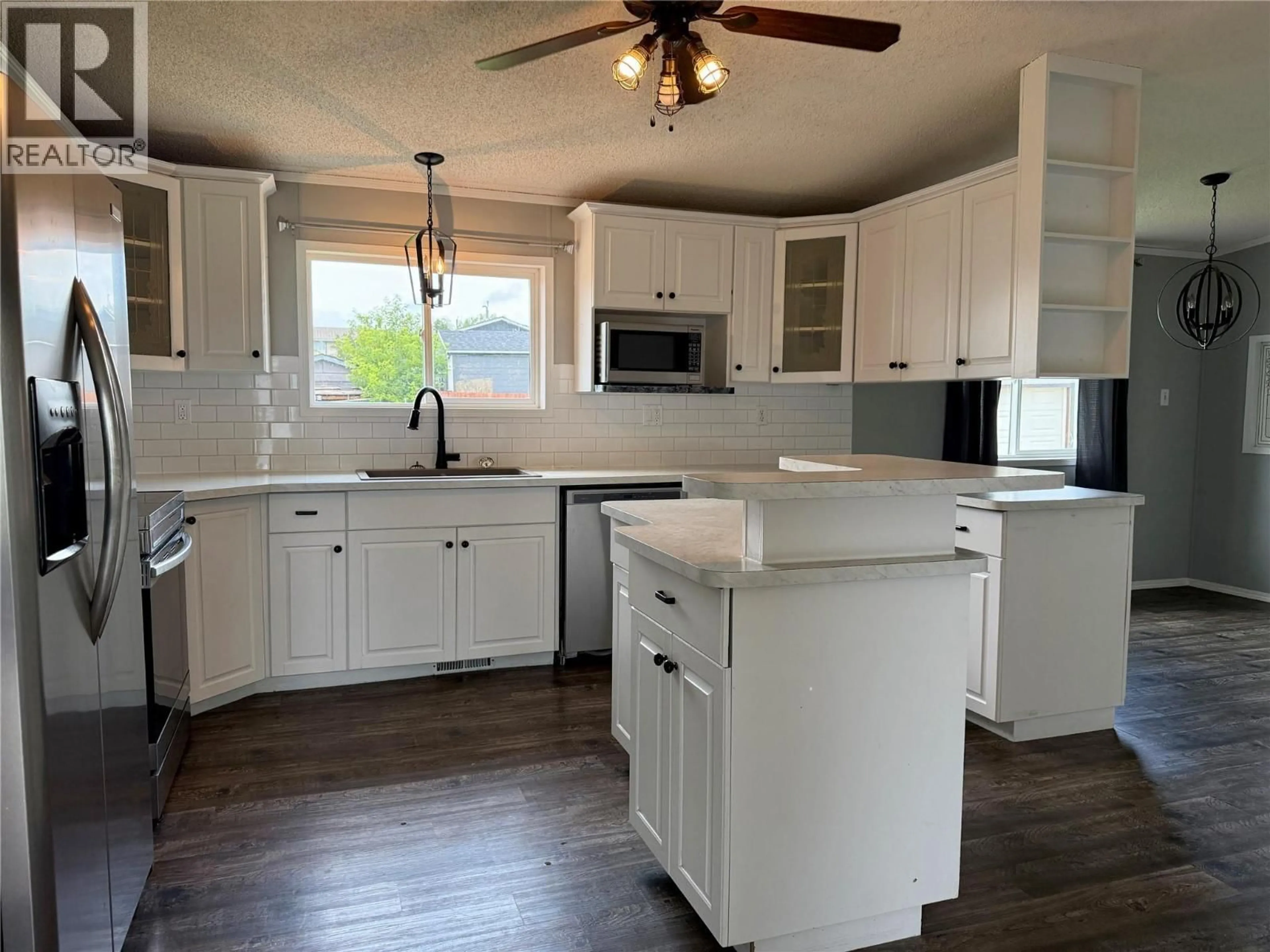 Open concept kitchen, wood/laminate floor for 500 99 AVENUE, Dawson Creek British Columbia V1G1T3