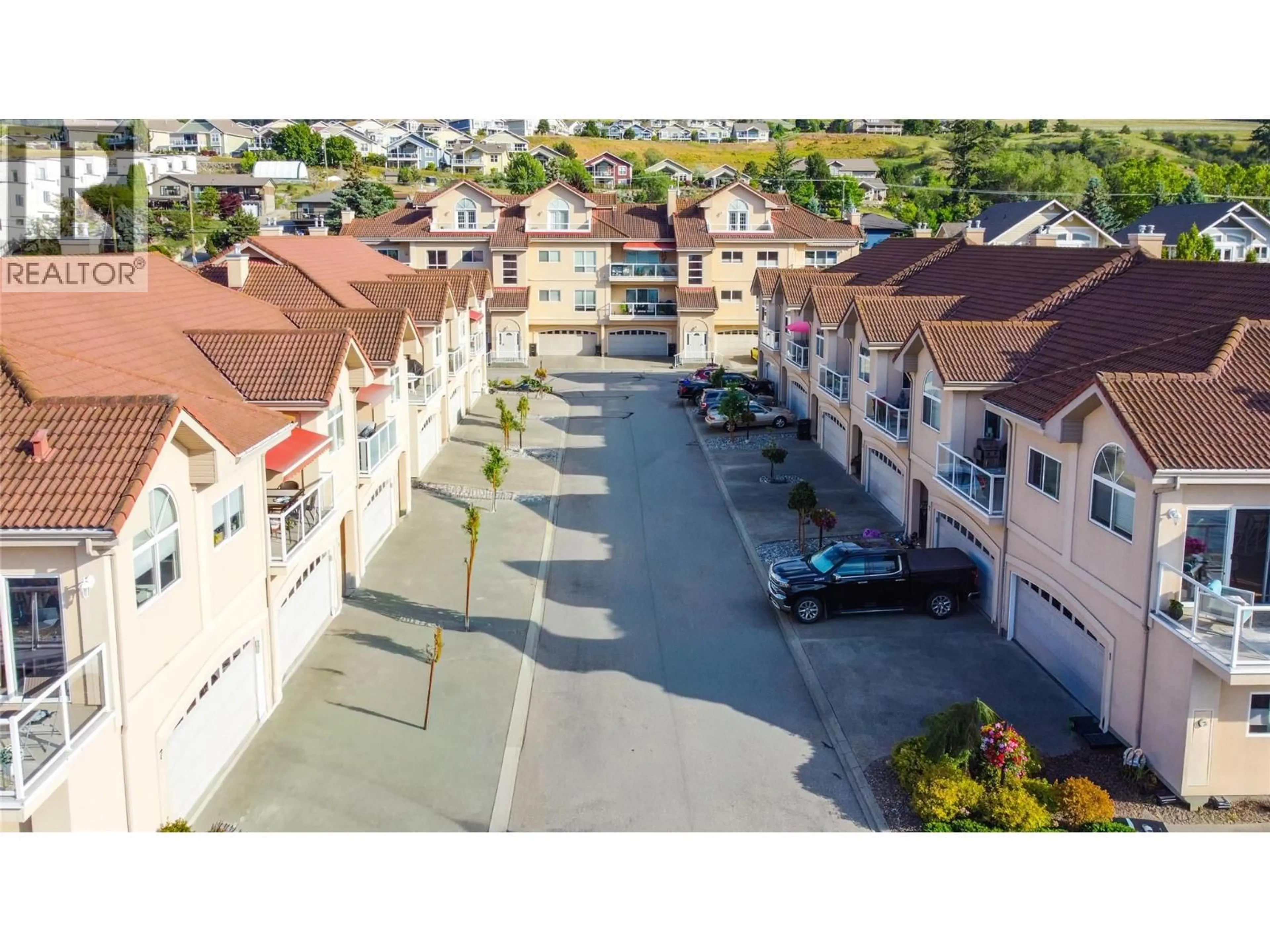 A pic from outside/outdoor area/front of a property/back of a property/a pic from drone, street for 13 - 7701 OKANAGAN LANDING ROAD, Vernon British Columbia V1H1L3