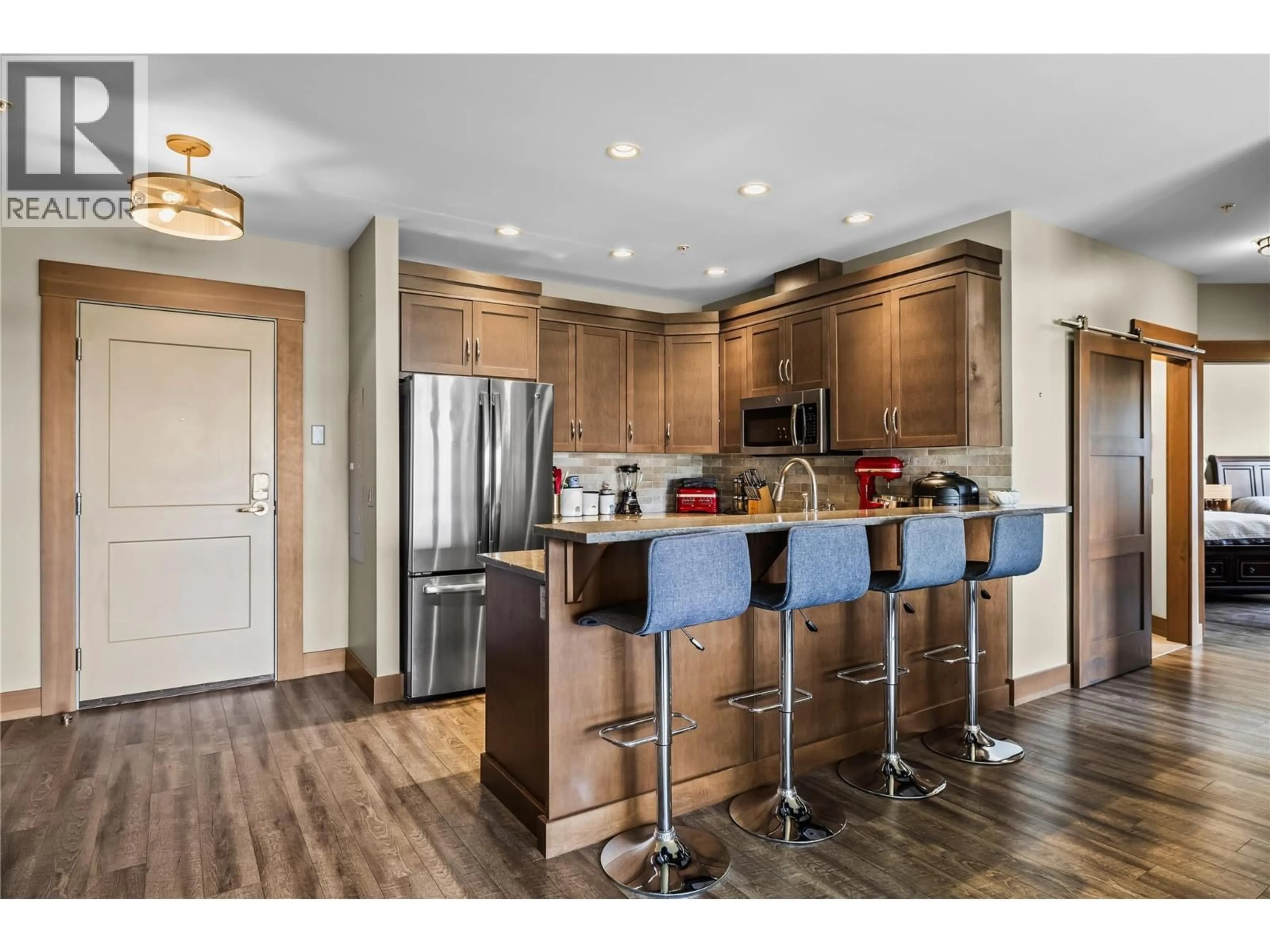 Open concept kitchen, wood/laminate floor for 203 - 5300B BIG WHITE ROAD, Big White British Columbia V1P1P3