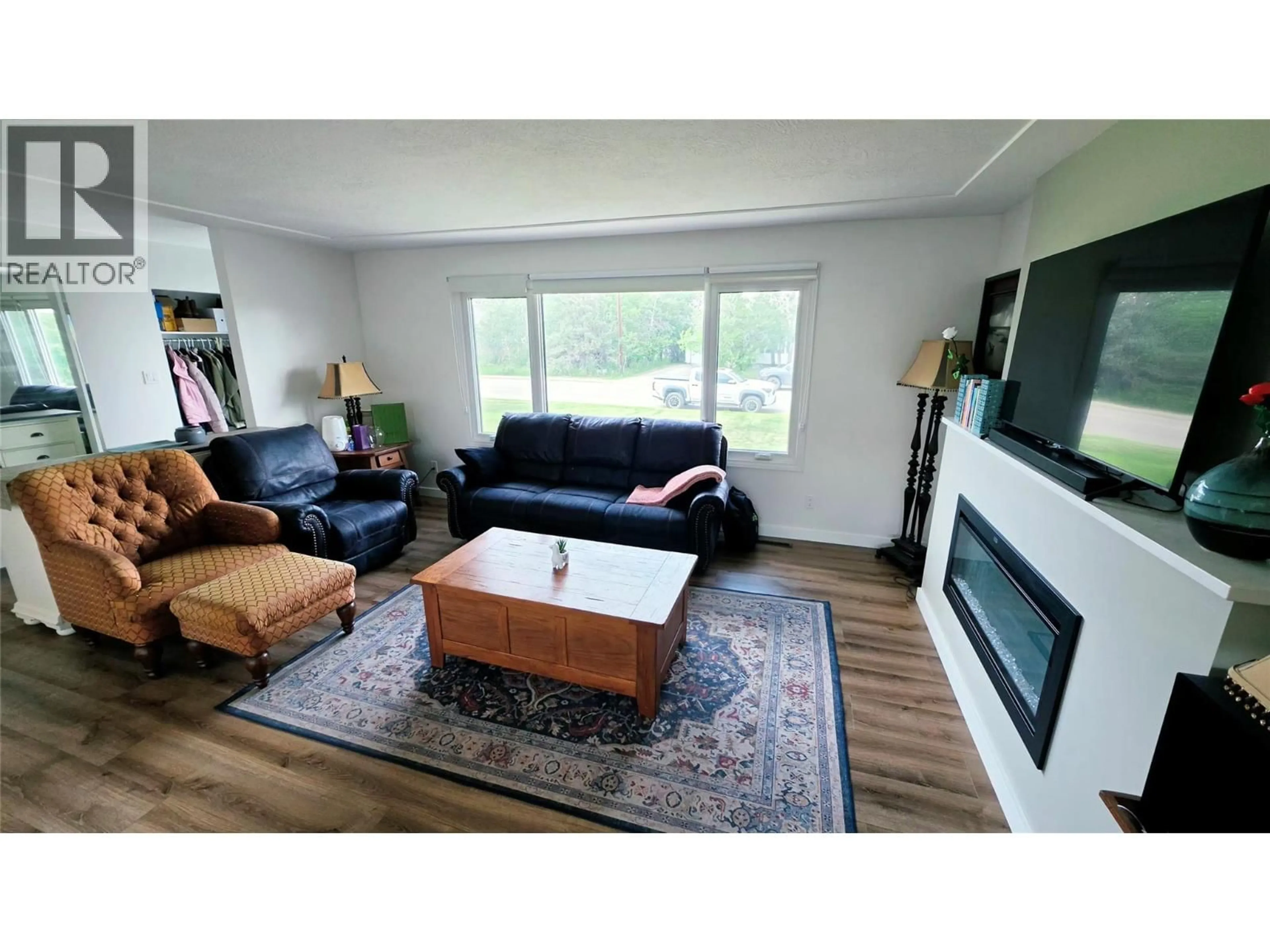 Living room with furniture, wood/laminate floor for 1405 108 AVENUE, Dawson Creek British Columbia V1G2T2