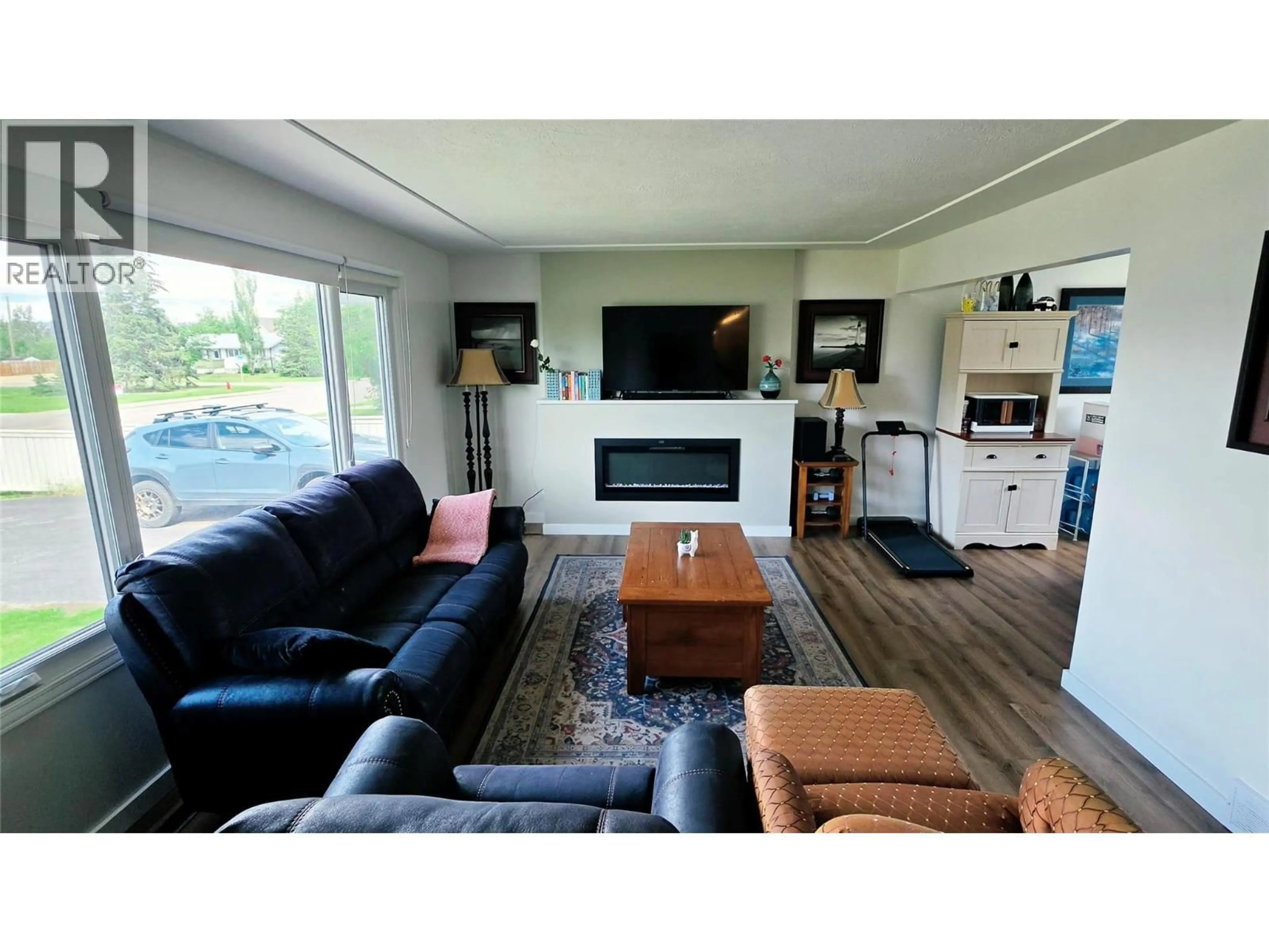 Living room with furniture, wood/laminate floor for 1405 108 AVENUE, Dawson Creek British Columbia V1G2T2