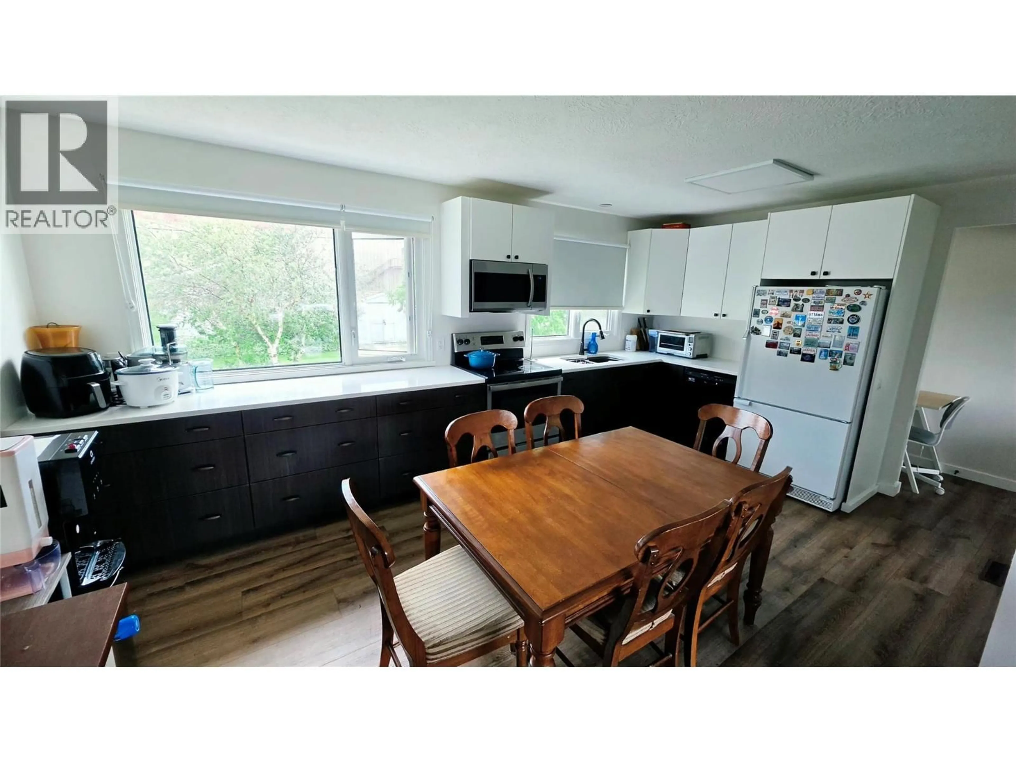 Open concept kitchen, wood/laminate floor for 1405 108 AVENUE, Dawson Creek British Columbia V1G2T2