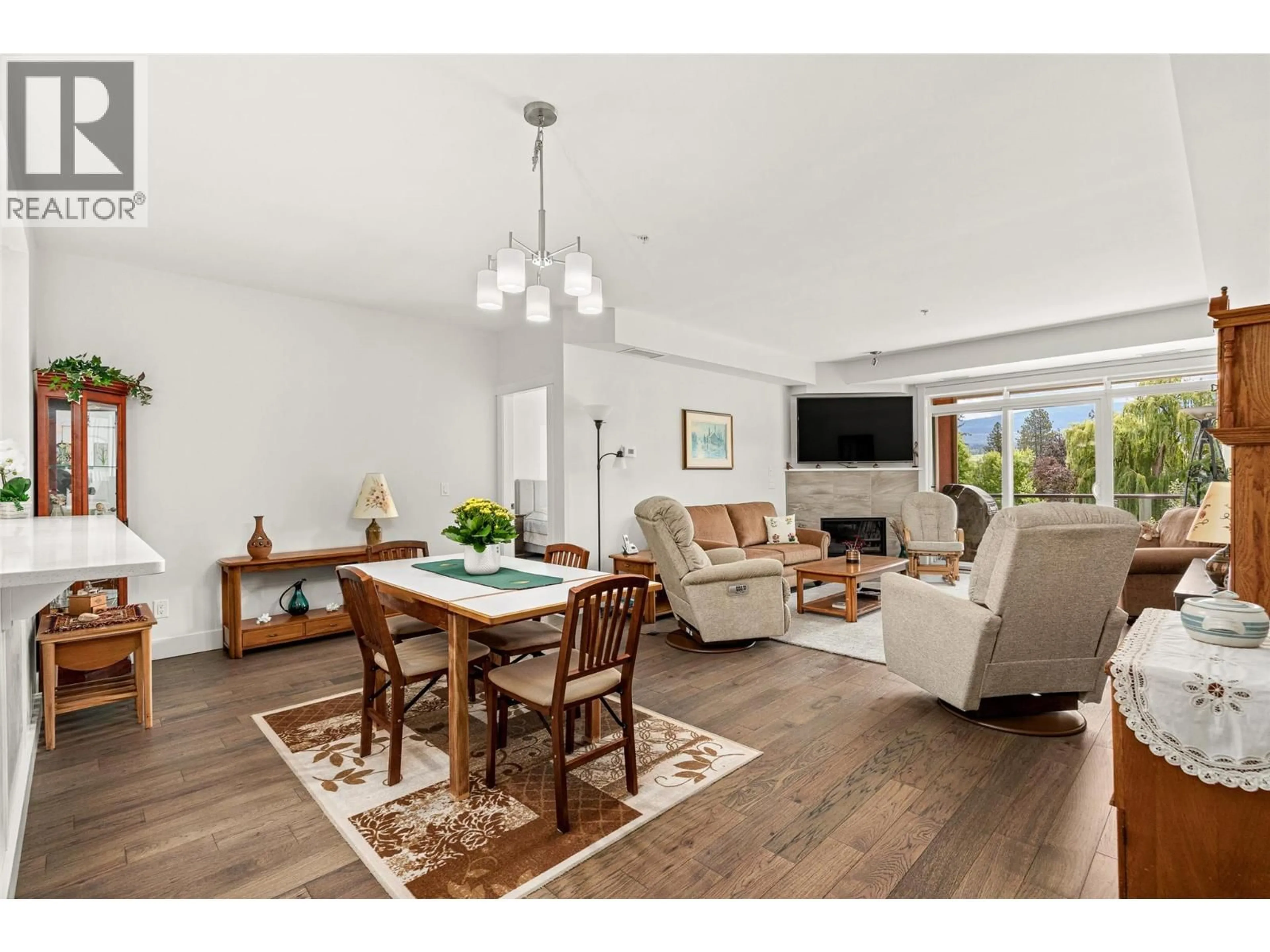 Living room with furniture, wood/laminate floor for 311 - 3865 TRUSWELL ROAD, Kelowna British Columbia V1W3K9