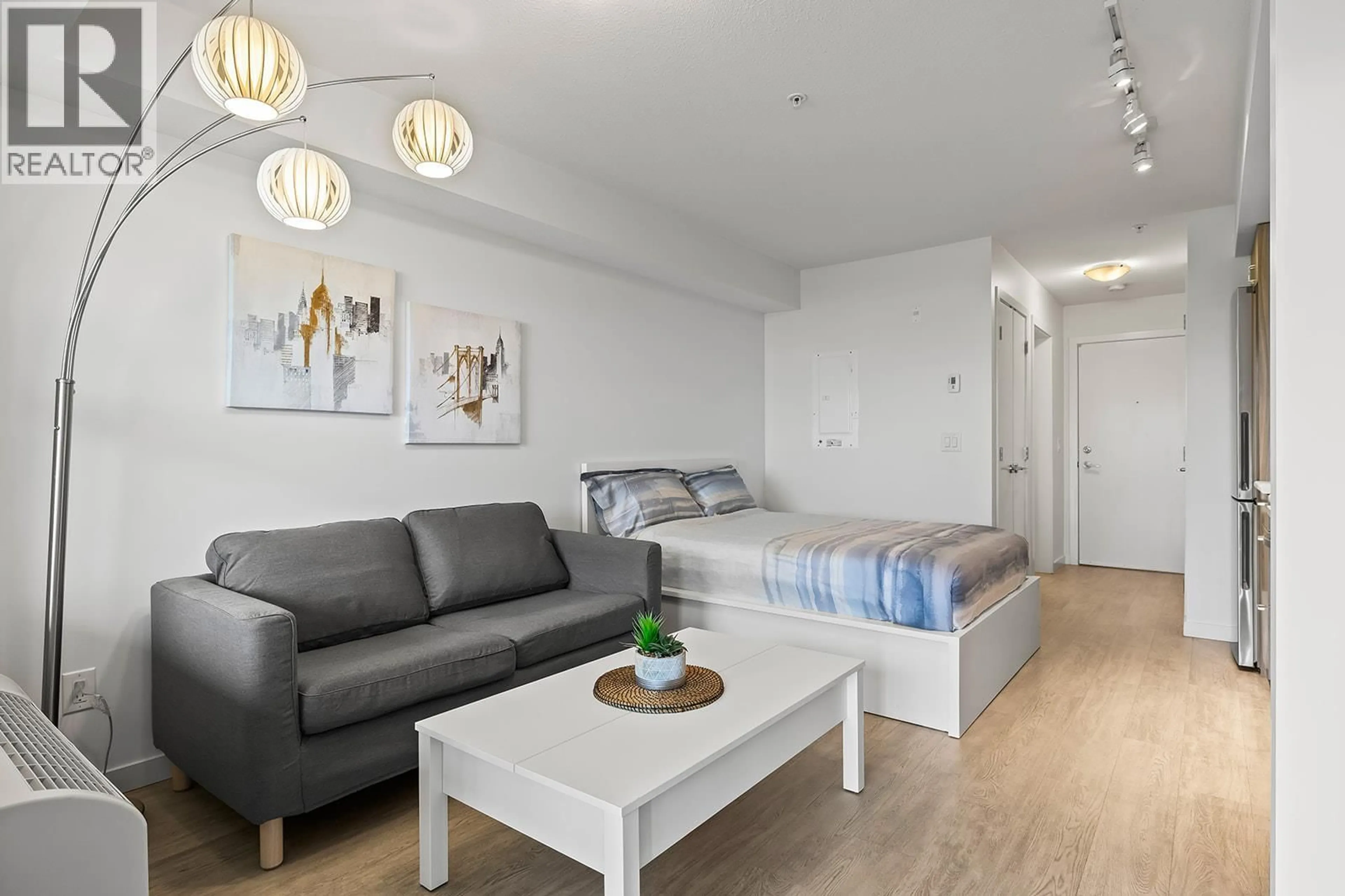Living room with furniture, wood/laminate floor for 119 - 695 ACADEMY WAY, Kelowna British Columbia V1V0C7
