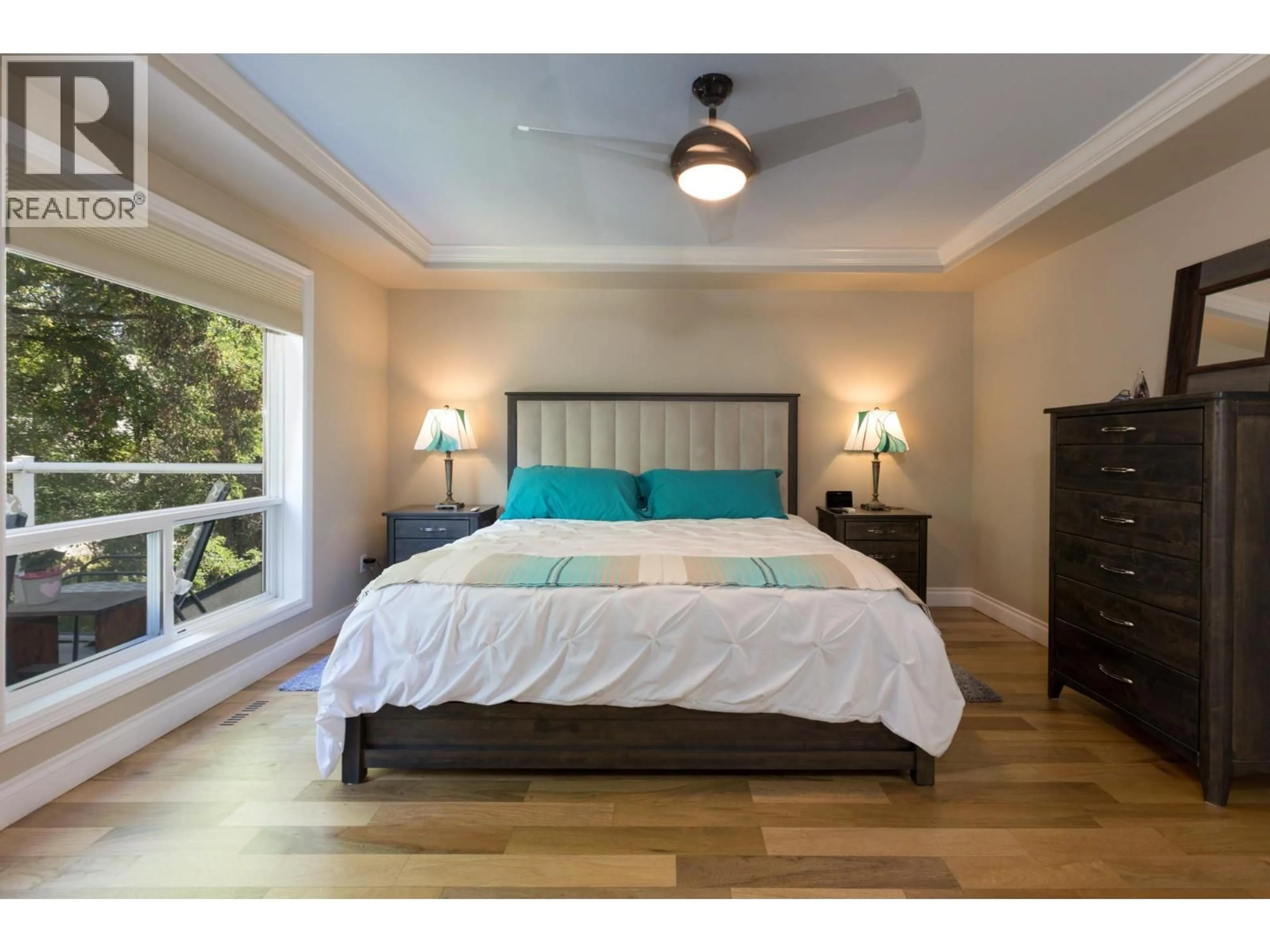 Bedroom with bed, wood/laminate floor for 101 - 550 ELLIOT AVENUE, Kelowna British Columbia V1Y5S8