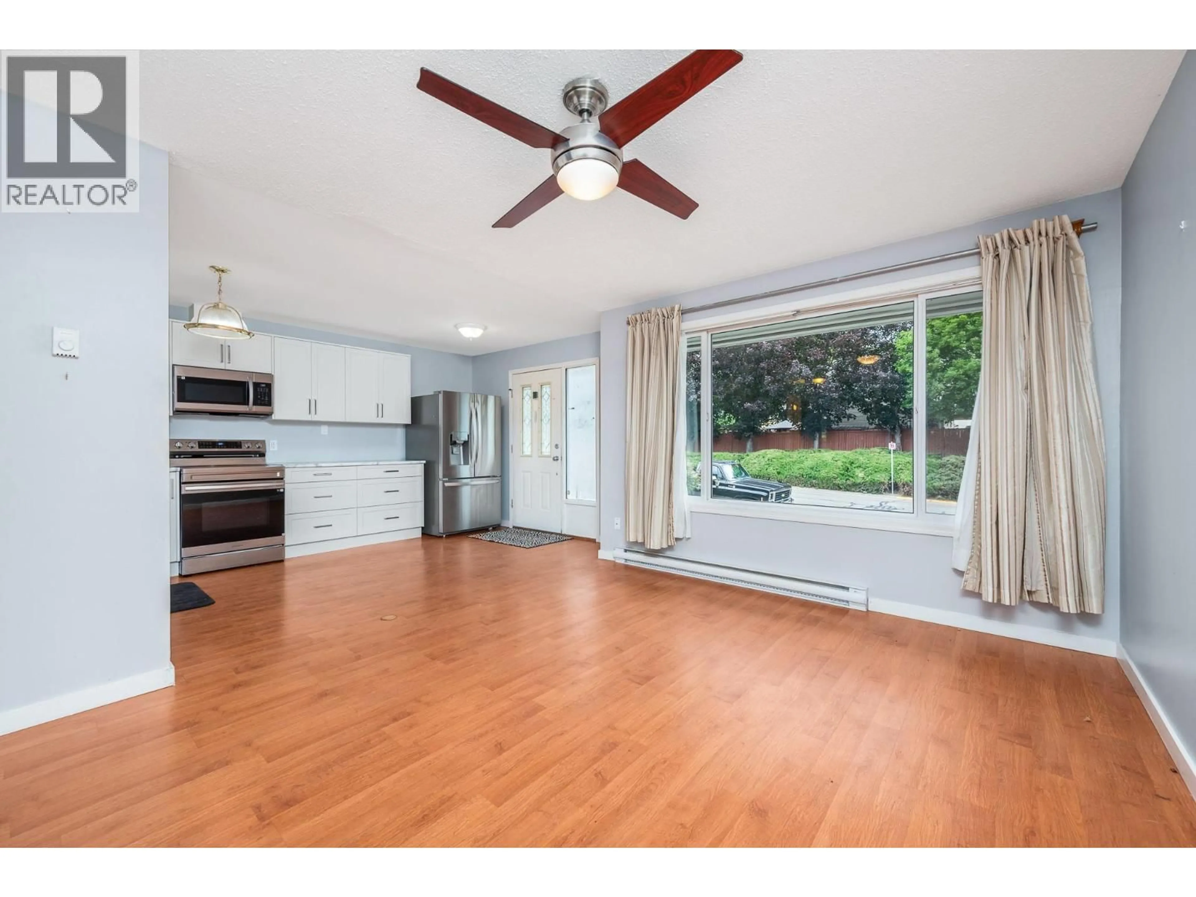 Open concept kitchen, wood/laminate floor for 5008 HERITAGE DRIVE, Vernon British Columbia V1T7V4