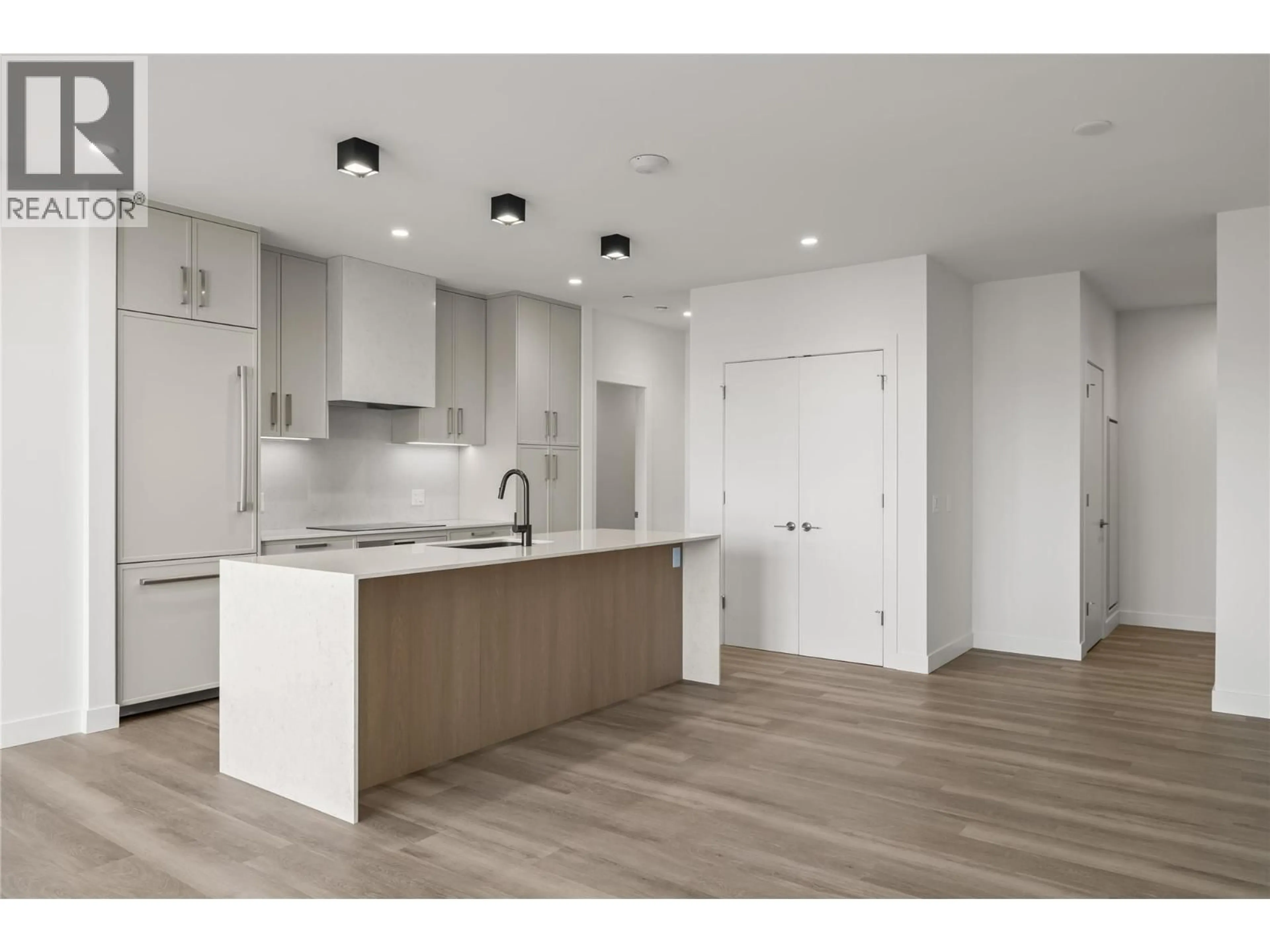 Open concept kitchen, wood/laminate floor for 306 - 3340 LAKESHORE DRIVE, Kelowna British Columbia V1W0H6
