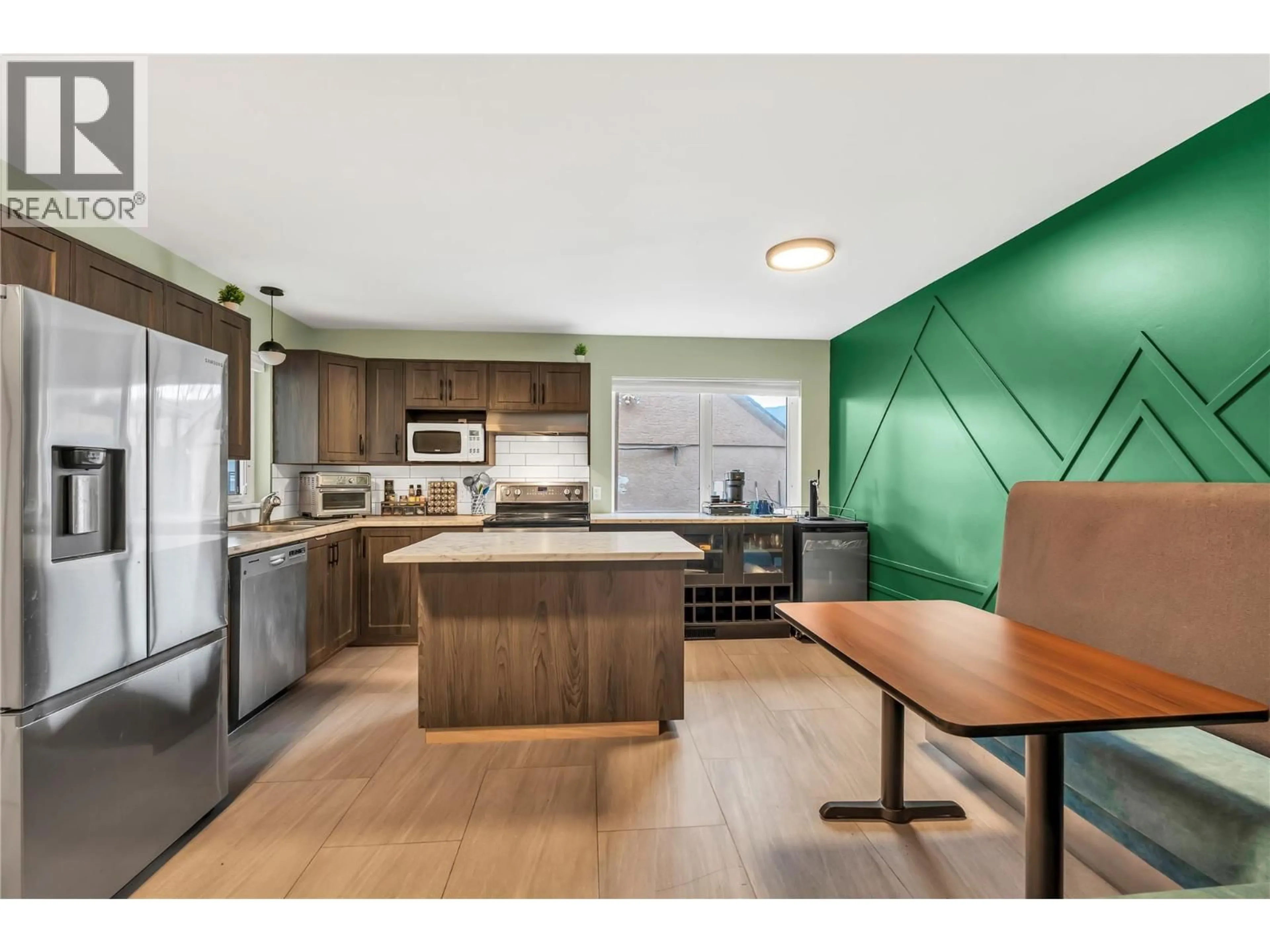 Open concept kitchen, wood/laminate floor for 429 BRAID ST OTHER, Penticton British Columbia V2A4Y2