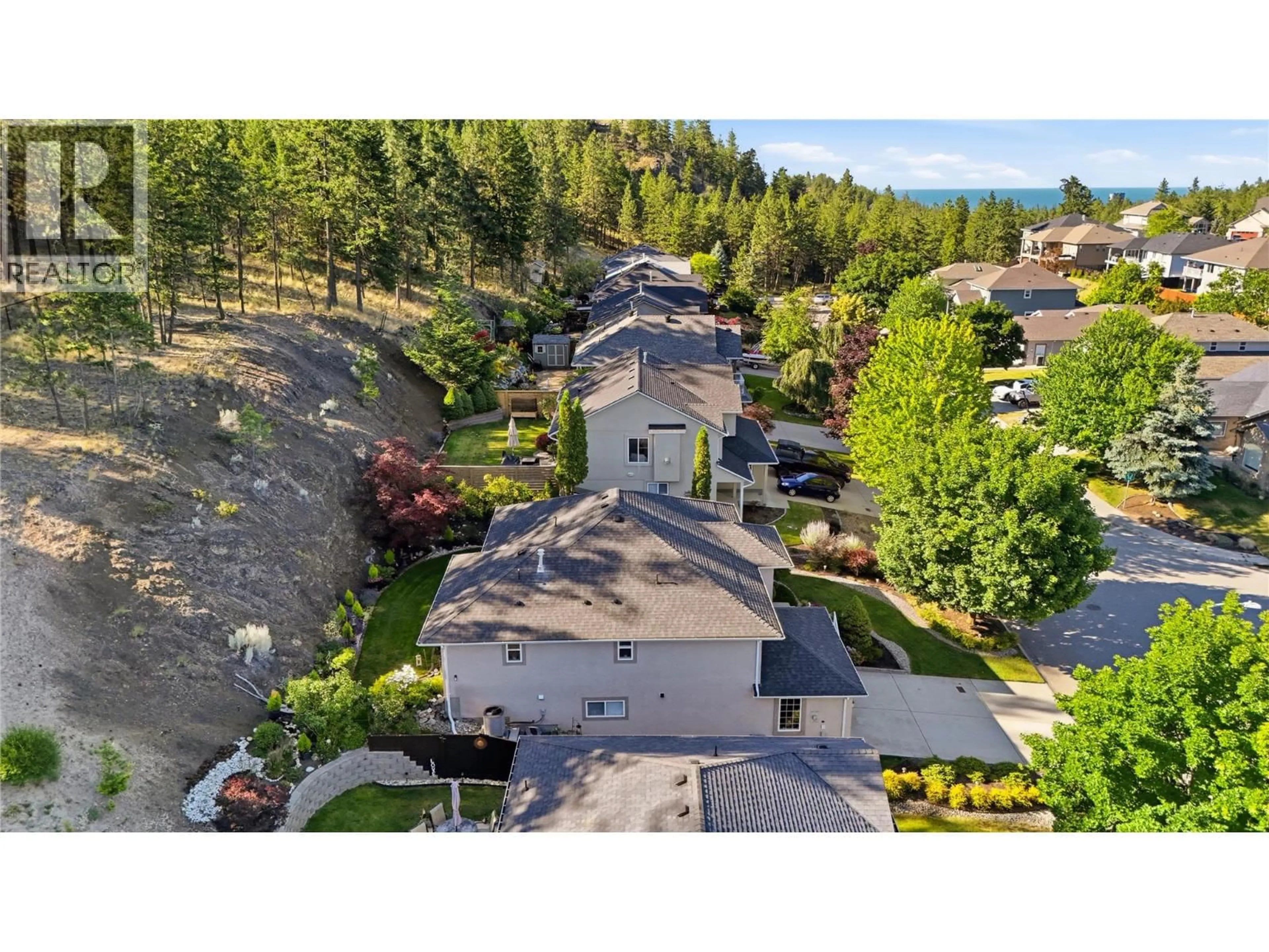 A pic from outside/outdoor area/front of a property/back of a property/a pic from drone, mountain view for 393 RIO DRIVE SOUTH, Kelowna British Columbia V1V2L2