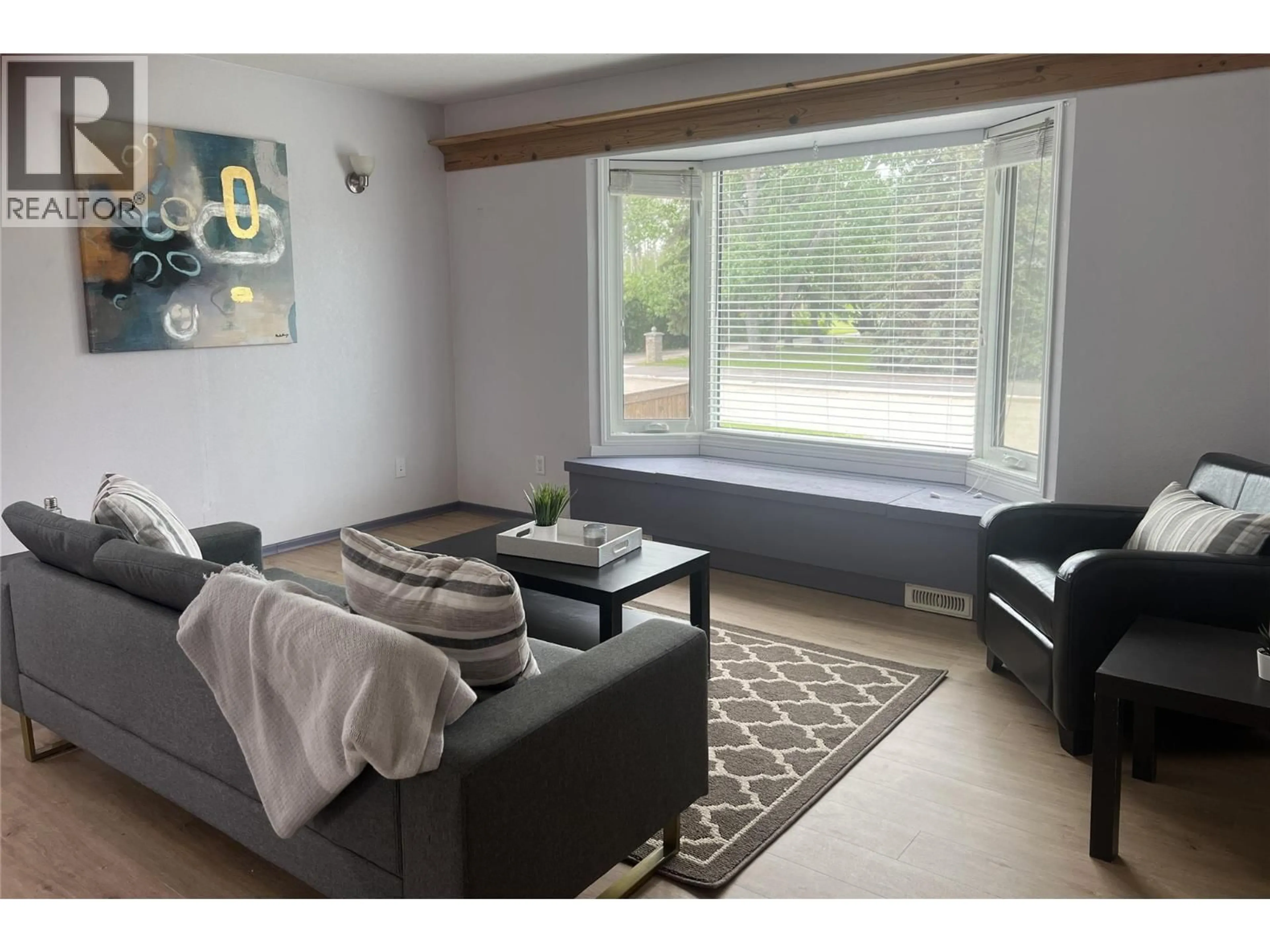 Living room with furniture, wood/laminate floor for 10208 18 STREET, Dawson Creek British Columbia V1G4E1