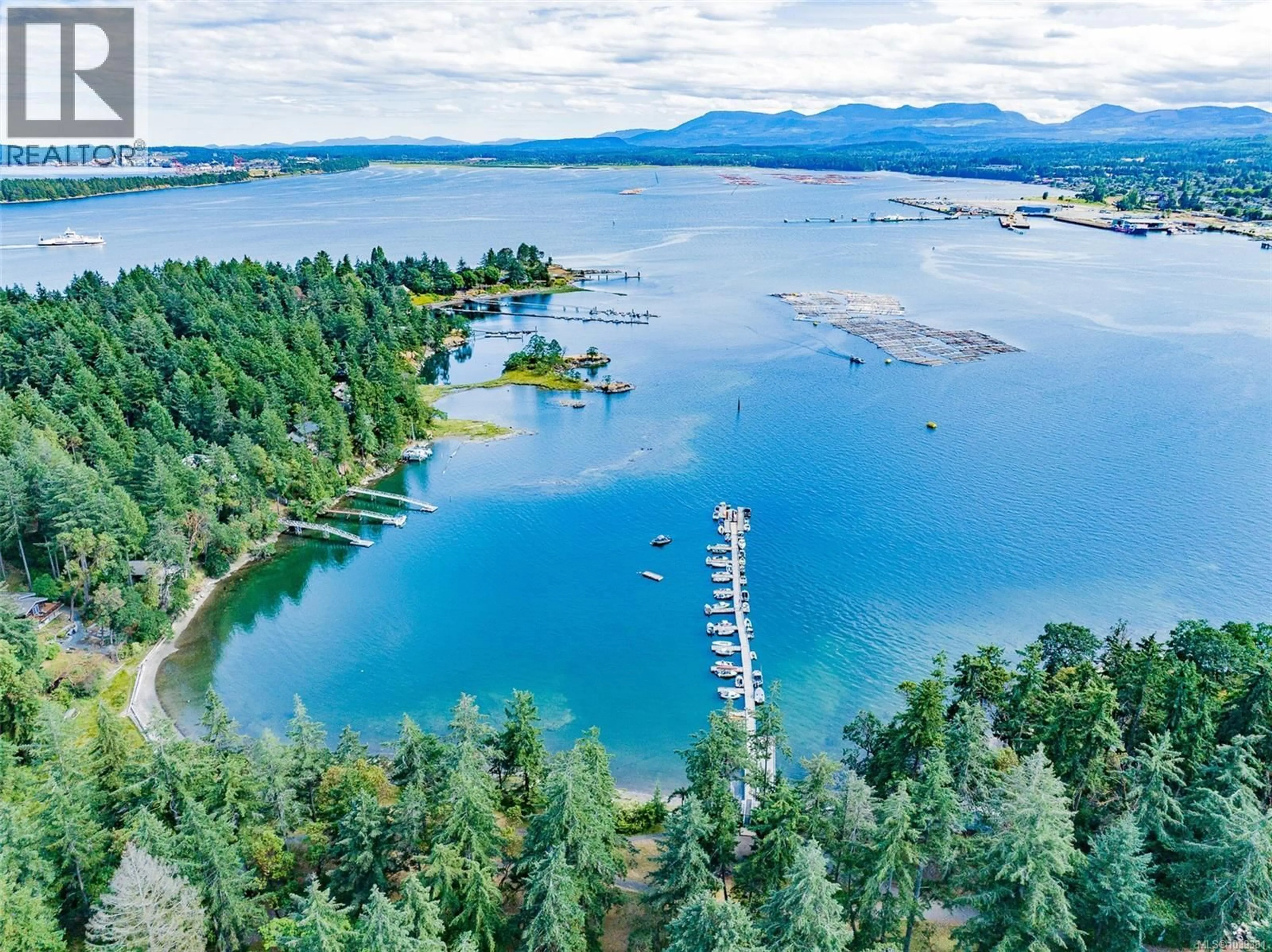 A pic from outside/outdoor area/front of a property/back of a property/a pic from drone, water/lake/river/ocean view for 7 PIRATES LANE, Protection Island British Columbia V0R2H0
