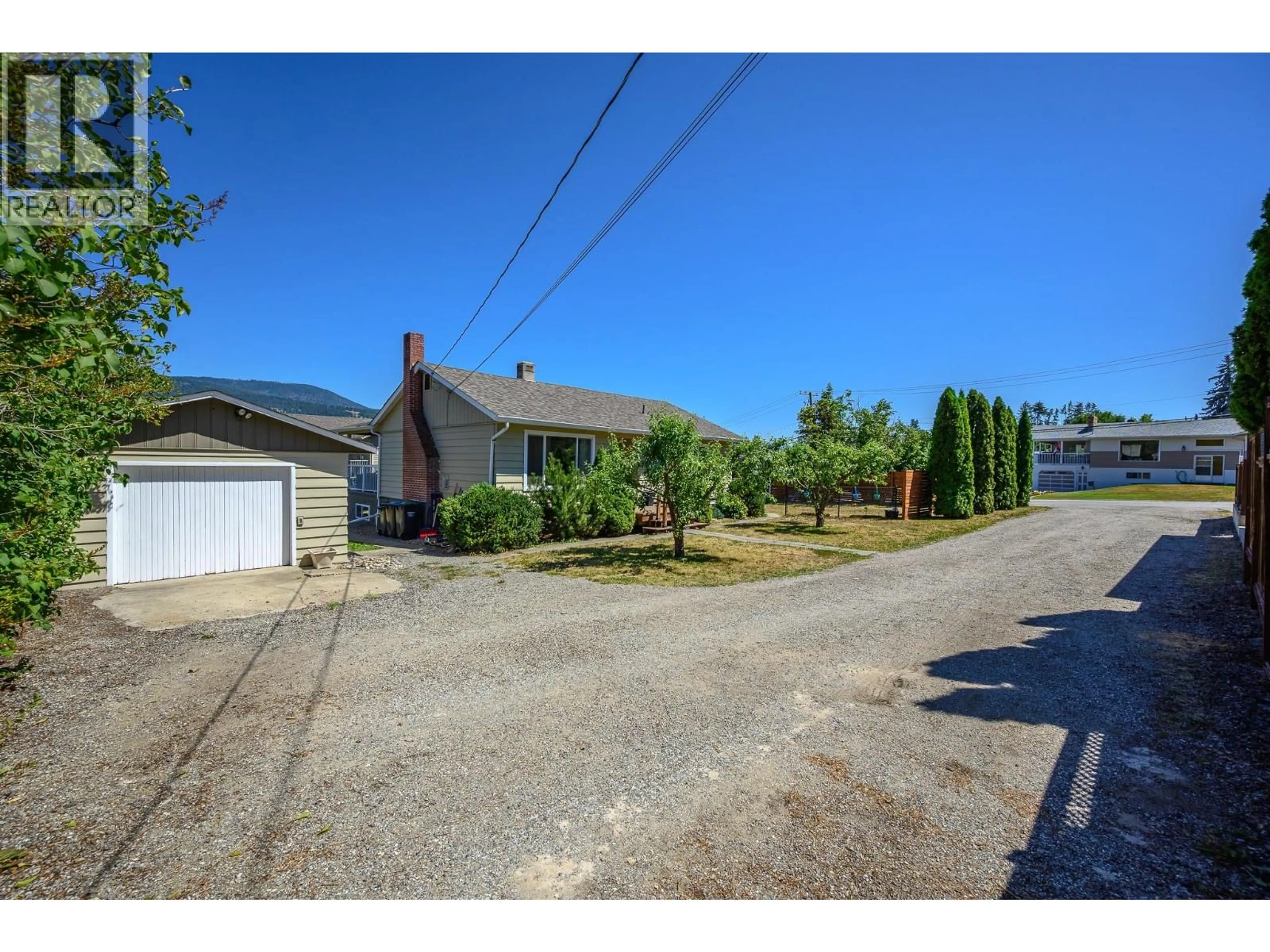 A pic from outside/outdoor area/front of a property/back of a property/a pic from drone, street for 2570 ROBINSON ROAD, Lake Country British Columbia V4V1G4