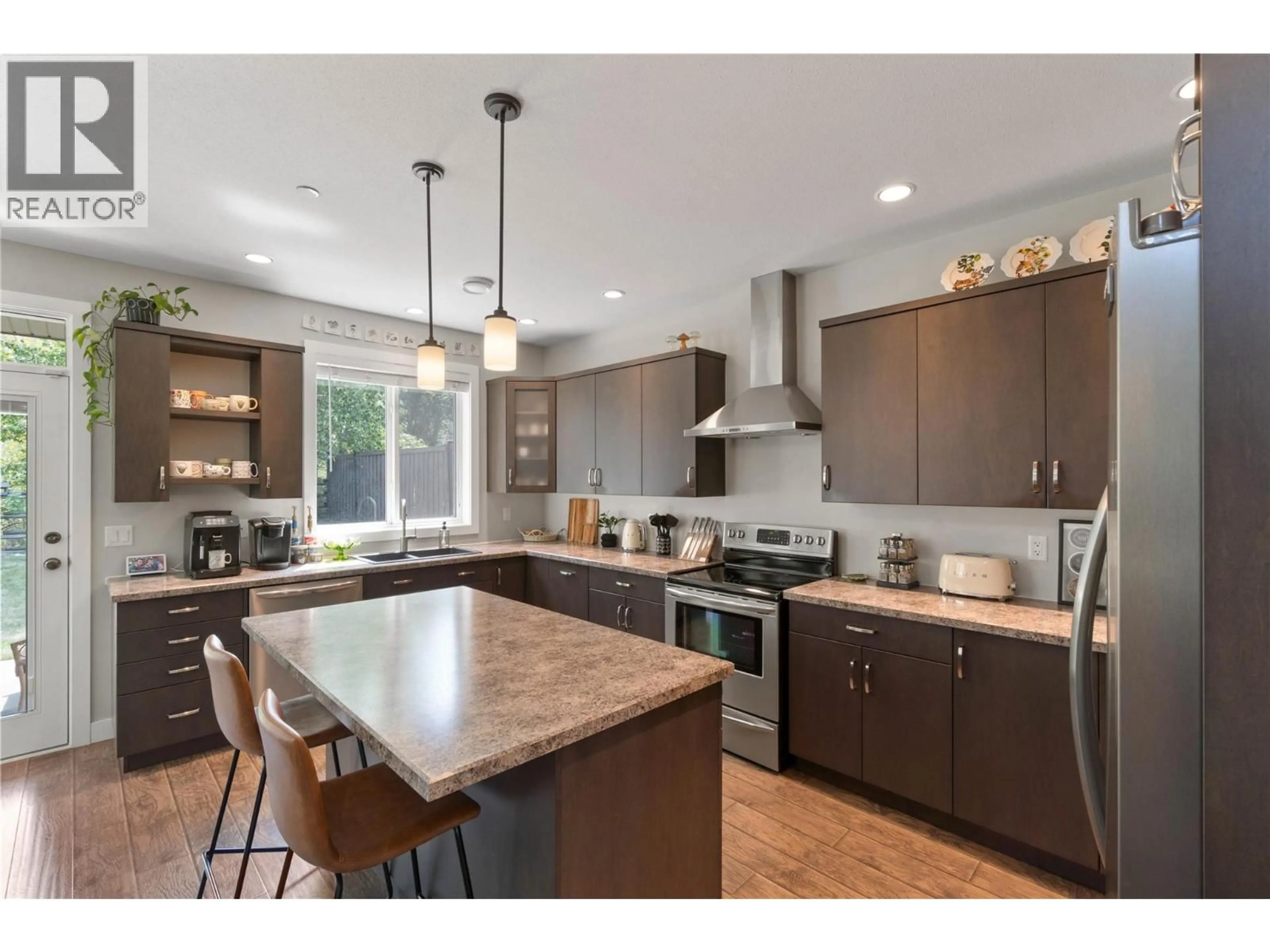 Open concept kitchen, wood/laminate floor for 8901 GRIZZLY CRESCENT, Kamloops British Columbia V2C6T9