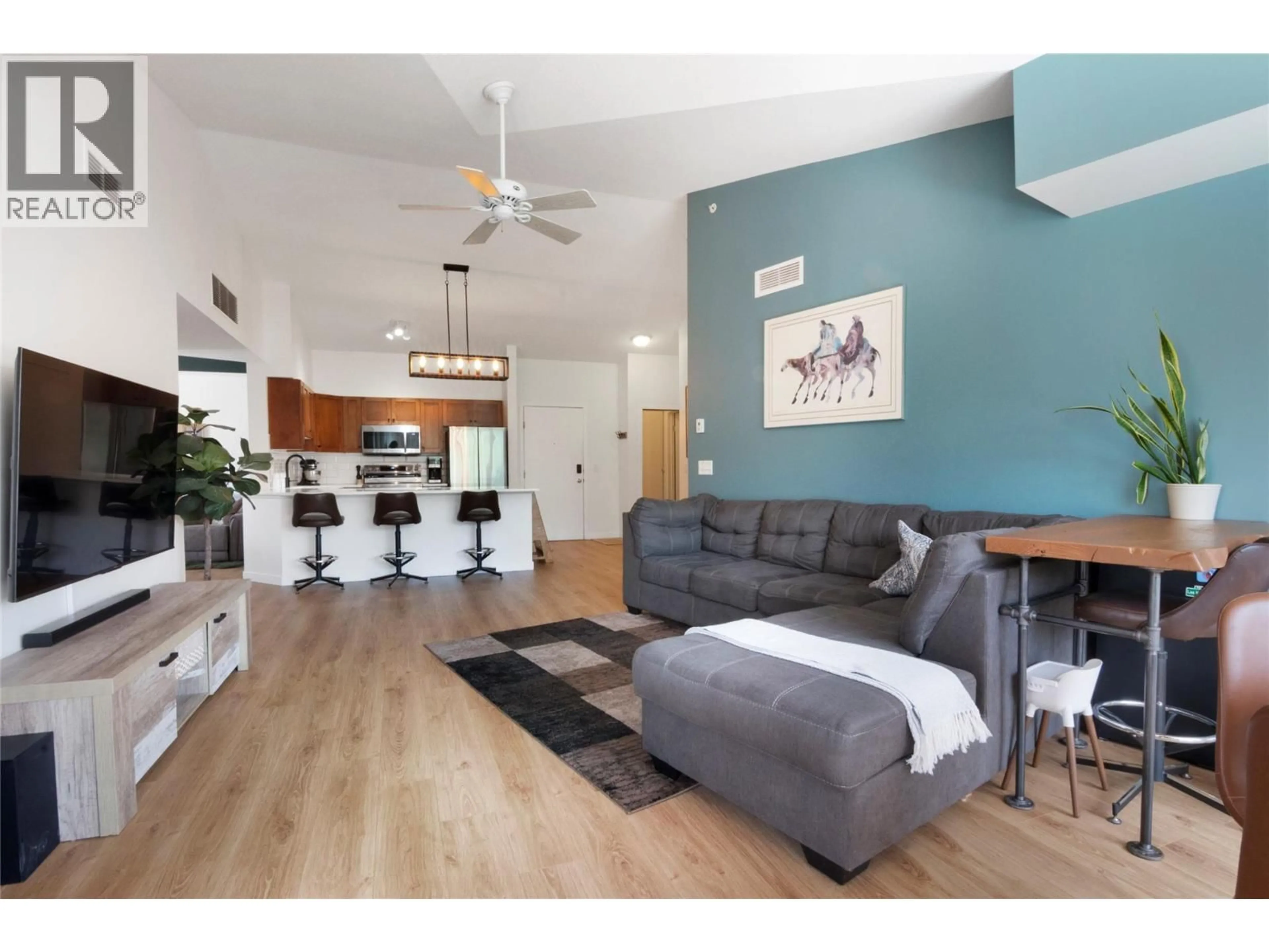 Living room with furniture, wood/laminate floor for 2403 - 3178 VIA CENTRALE ROAD, Kelowna British Columbia V1V2T3
