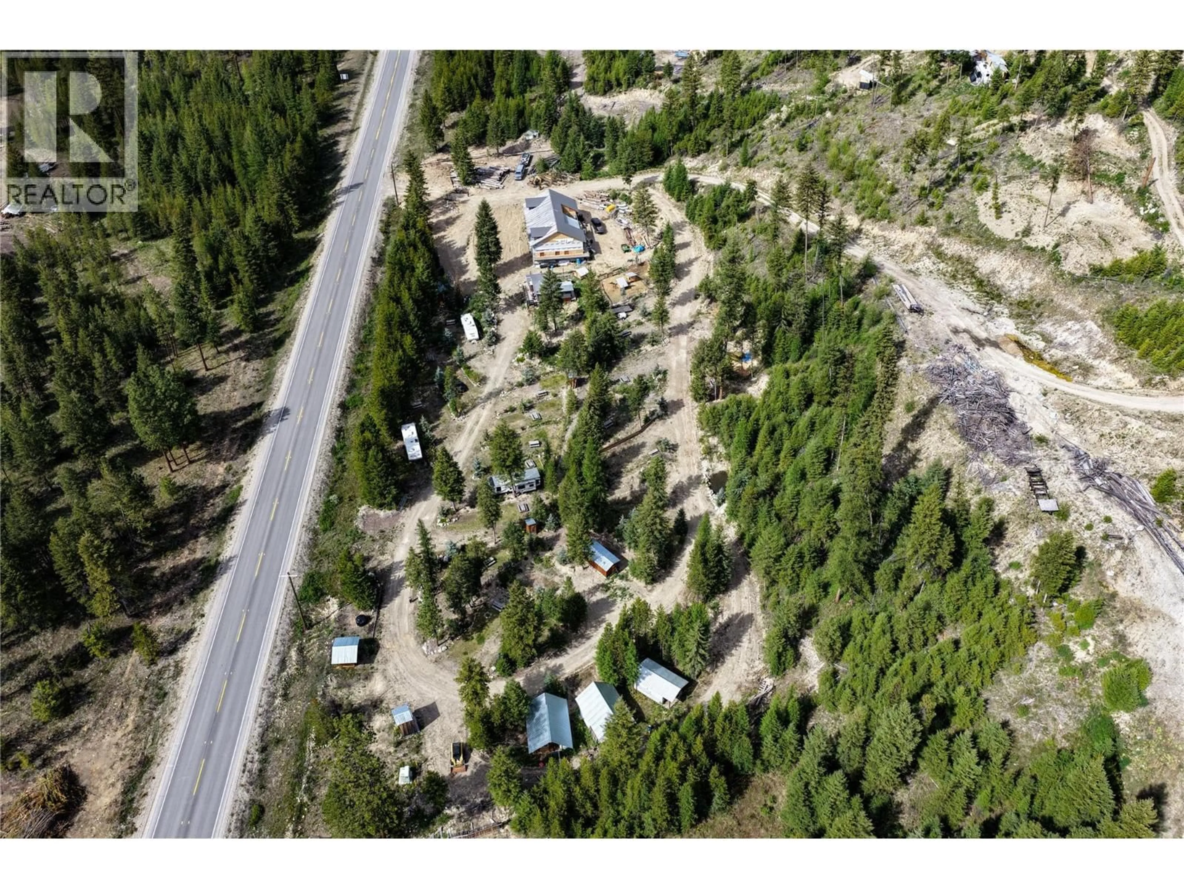 A pic from outside/outdoor area/front of a property/back of a property/a pic from drone, forest/trees view for 5550 HIGHWAY 33 HIGHWAY, Beaverdell British Columbia V0H1A0