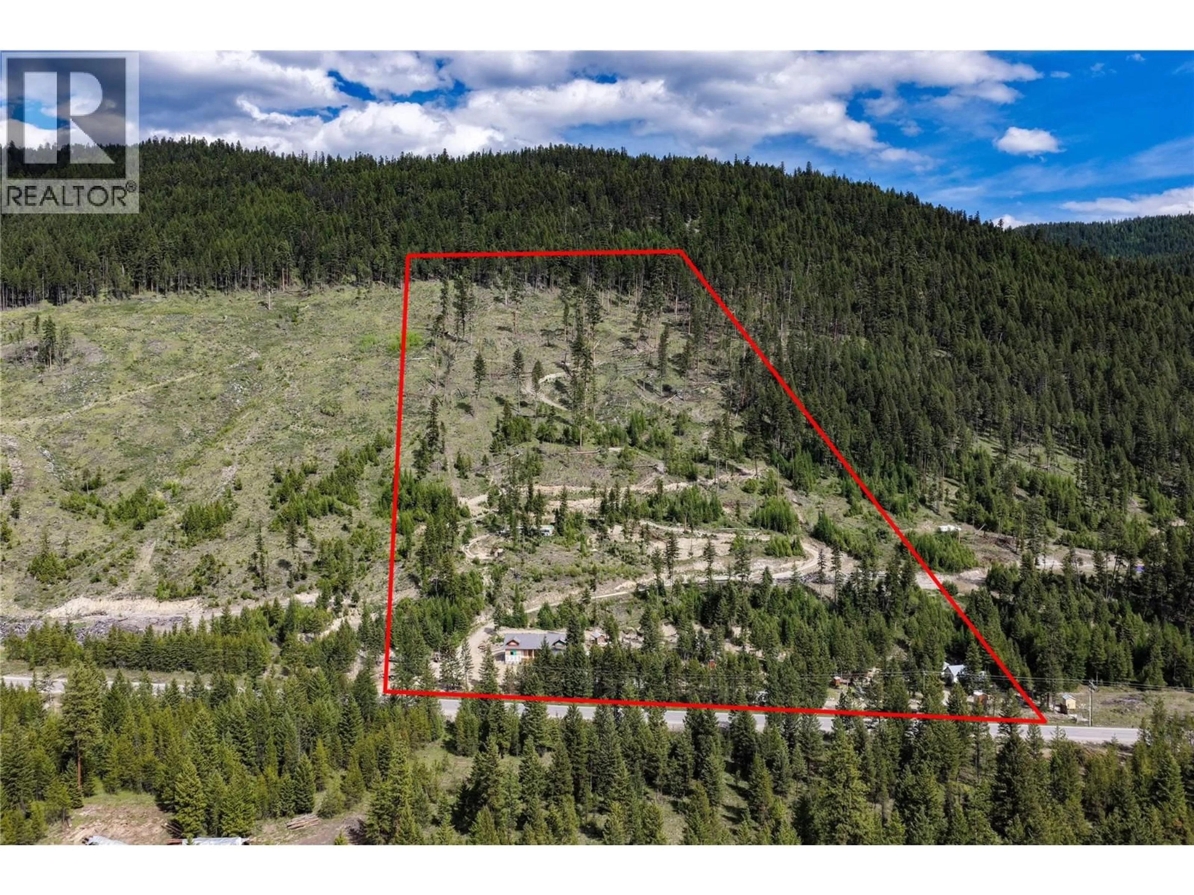 A pic from outside/outdoor area/front of a property/back of a property/a pic from drone, forest/trees view for 5550 HIGHWAY 33 HIGHWAY, Beaverdell British Columbia V0H1A0