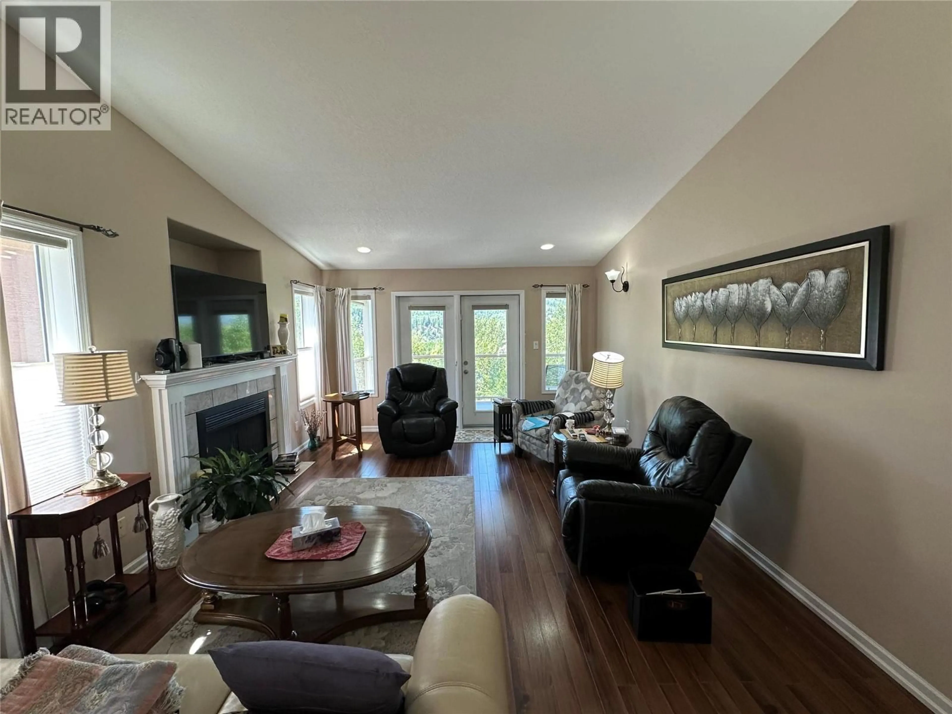 Living room with furniture, wood/laminate floor for 7968 BIRCHWOOD DRIVE, Trail British Columbia V1R4Y3
