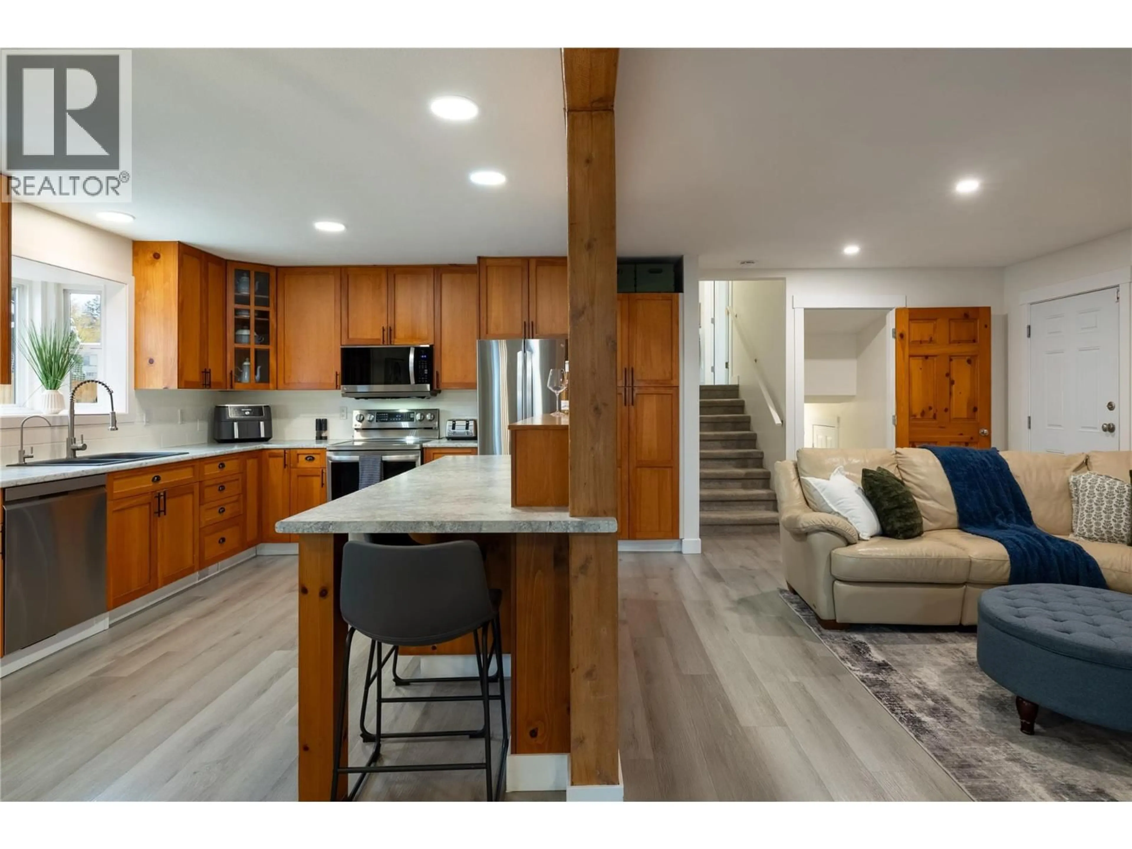 Open concept kitchen, wood/laminate floor for 5301 SPALDING ROAD, Vernon British Columbia V1B3K5