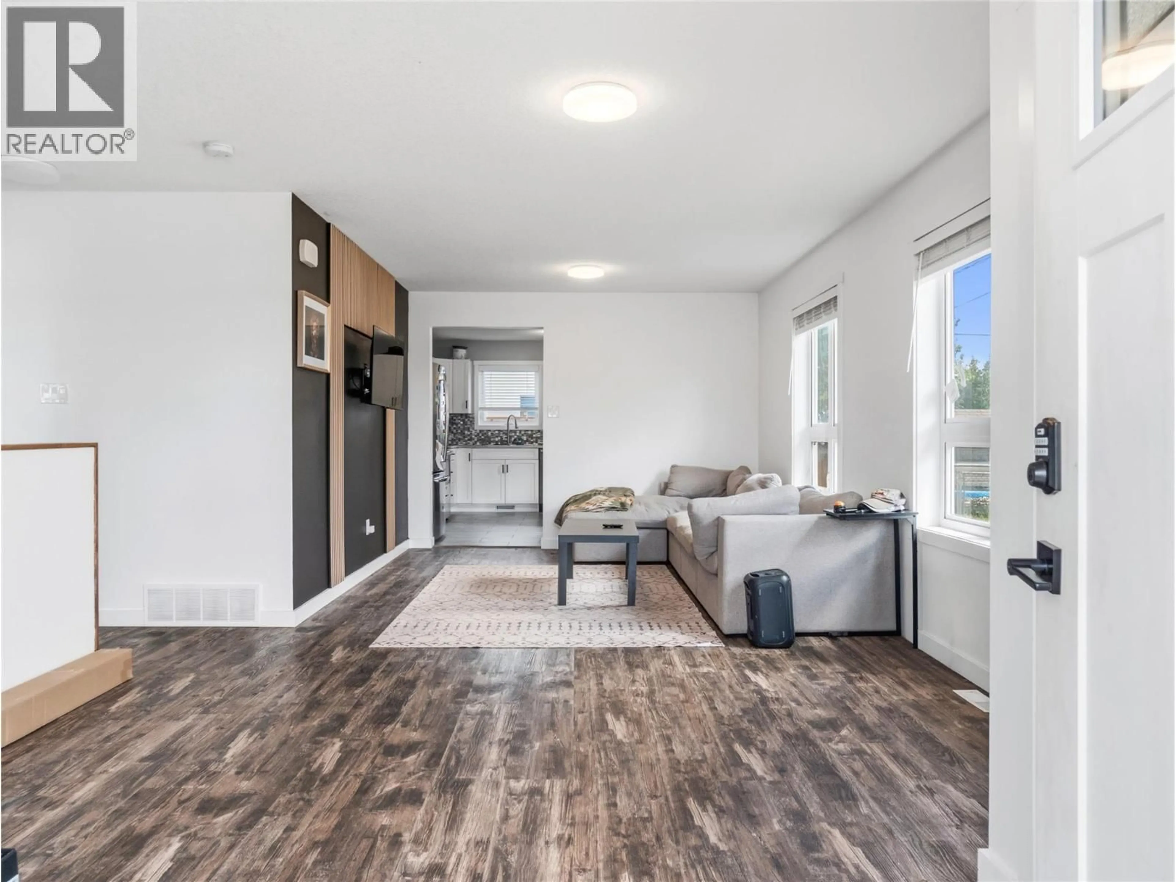 Living room with furniture, wood/laminate floor for 1104 104 AVENUE, Dawson Creek British Columbia V1G2J2