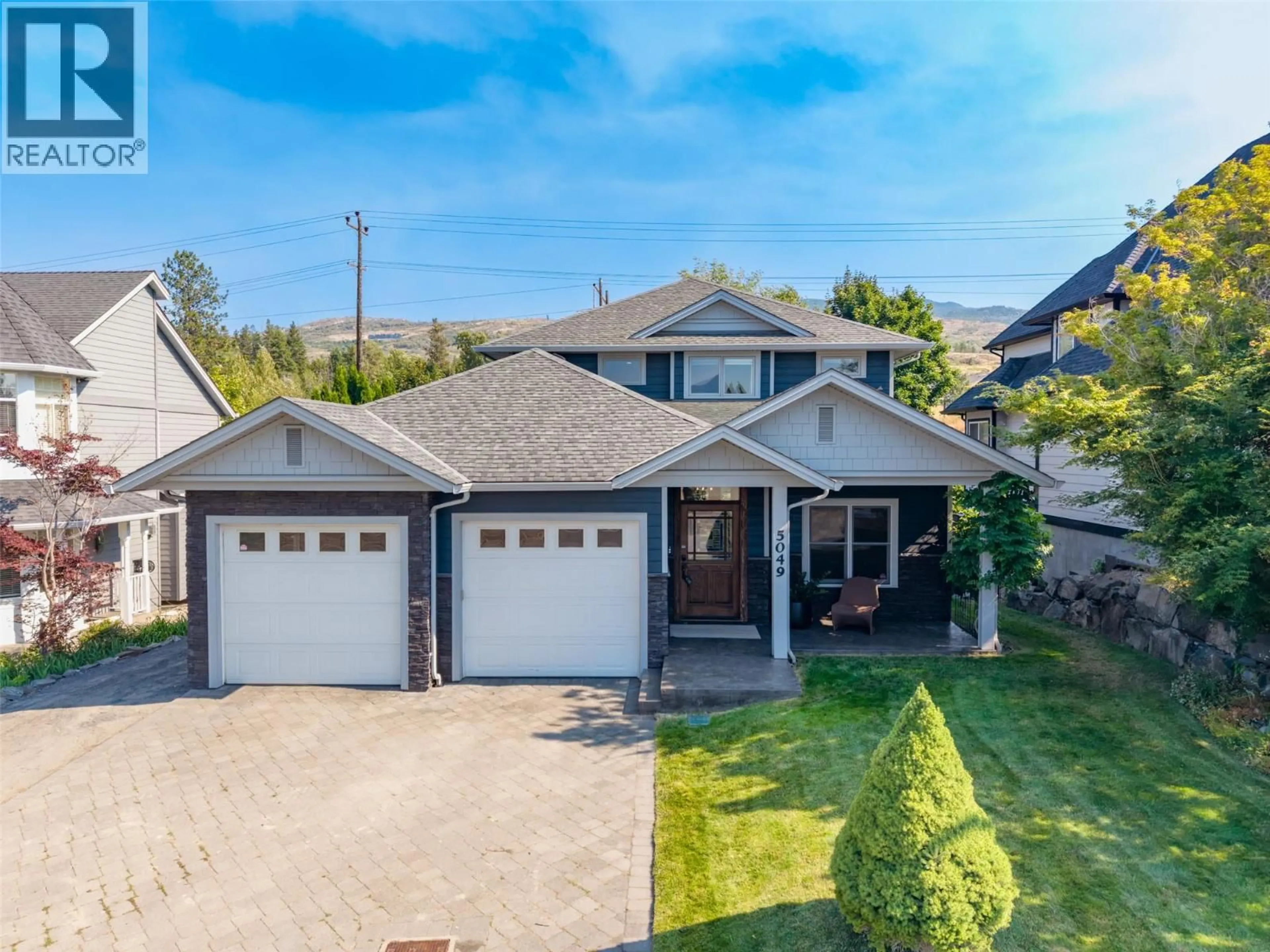 A pic from outside/outdoor area/front of a property/back of a property/a pic from drone, street for 5049 TREADGOLD COURT, Kelowna British Columbia V1W5B4