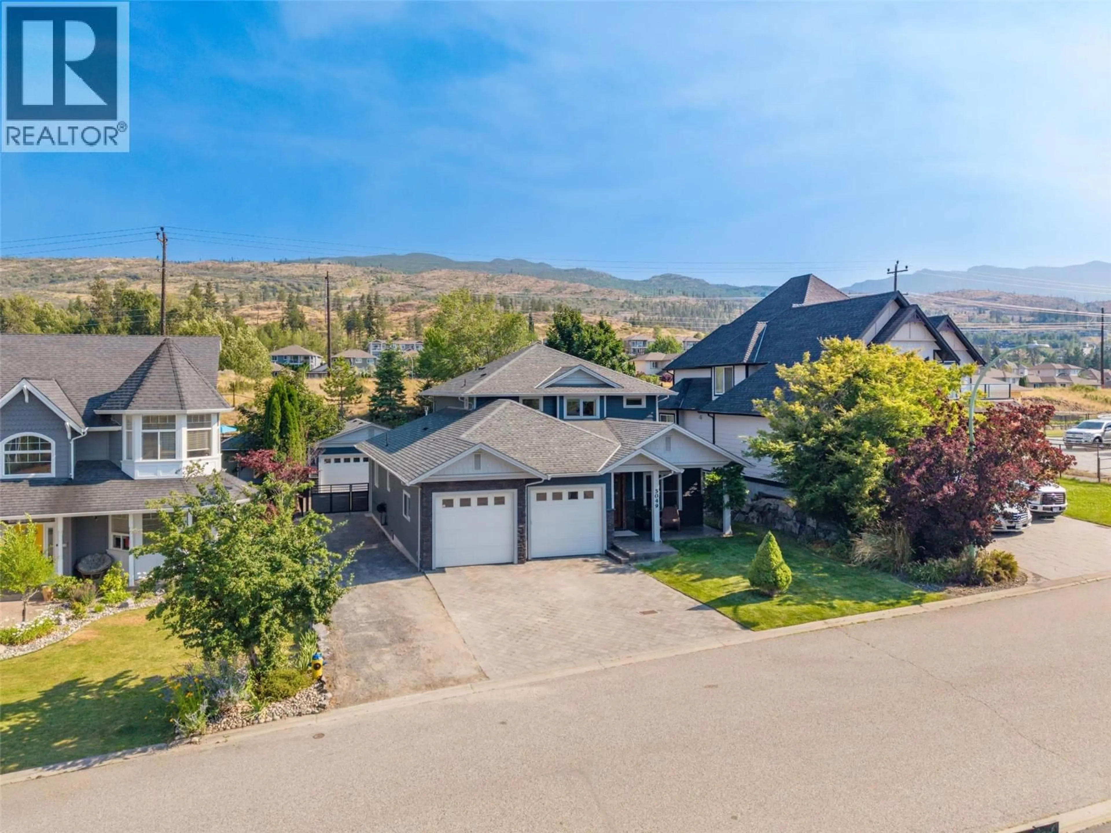 A pic from outside/outdoor area/front of a property/back of a property/a pic from drone, mountain view for 5049 TREADGOLD COURT, Kelowna British Columbia V1W5B4
