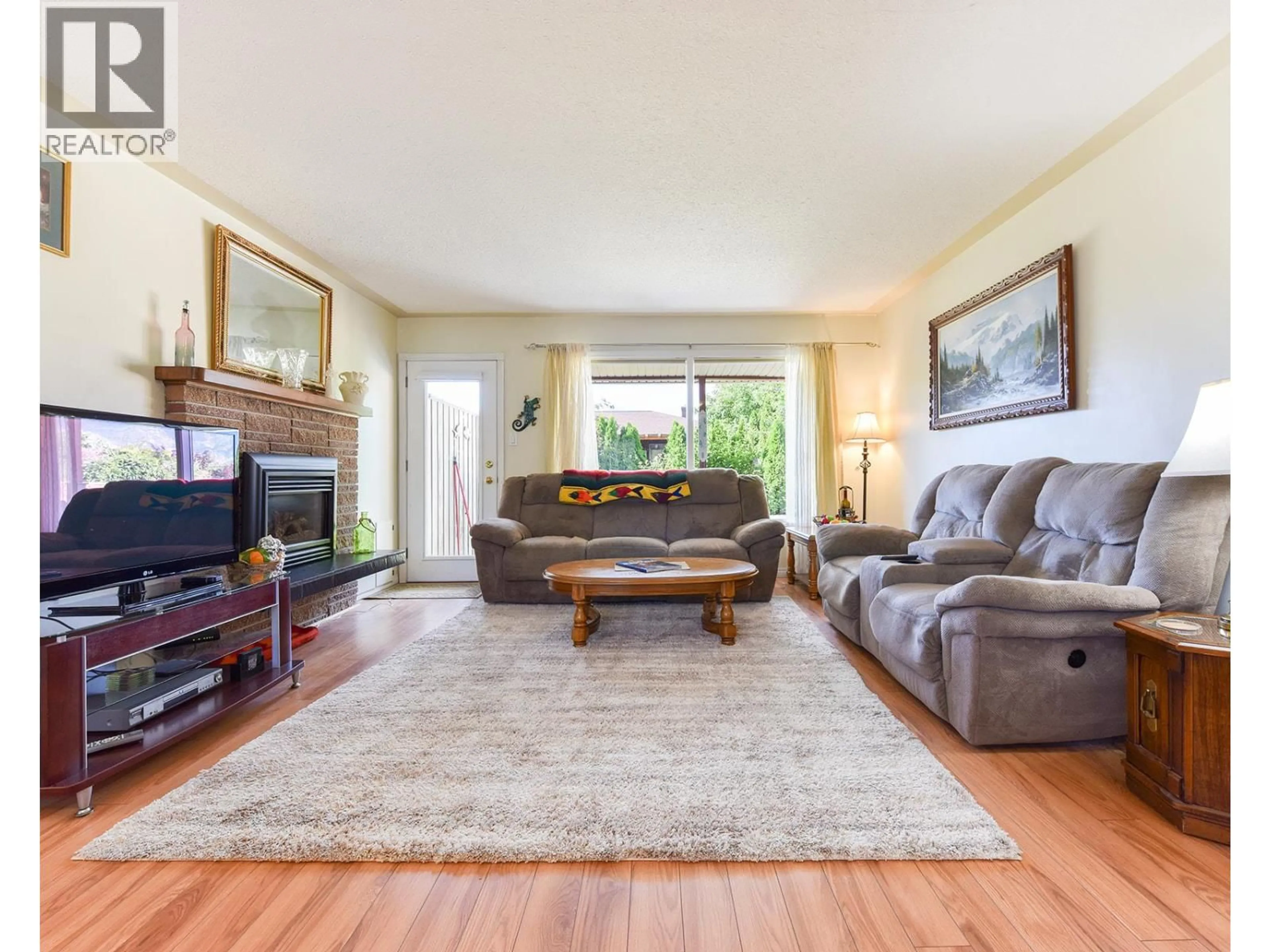 Living room with furniture, wood/laminate floor for 52 GRANBY PLACE, Penticton British Columbia V2A2Z4