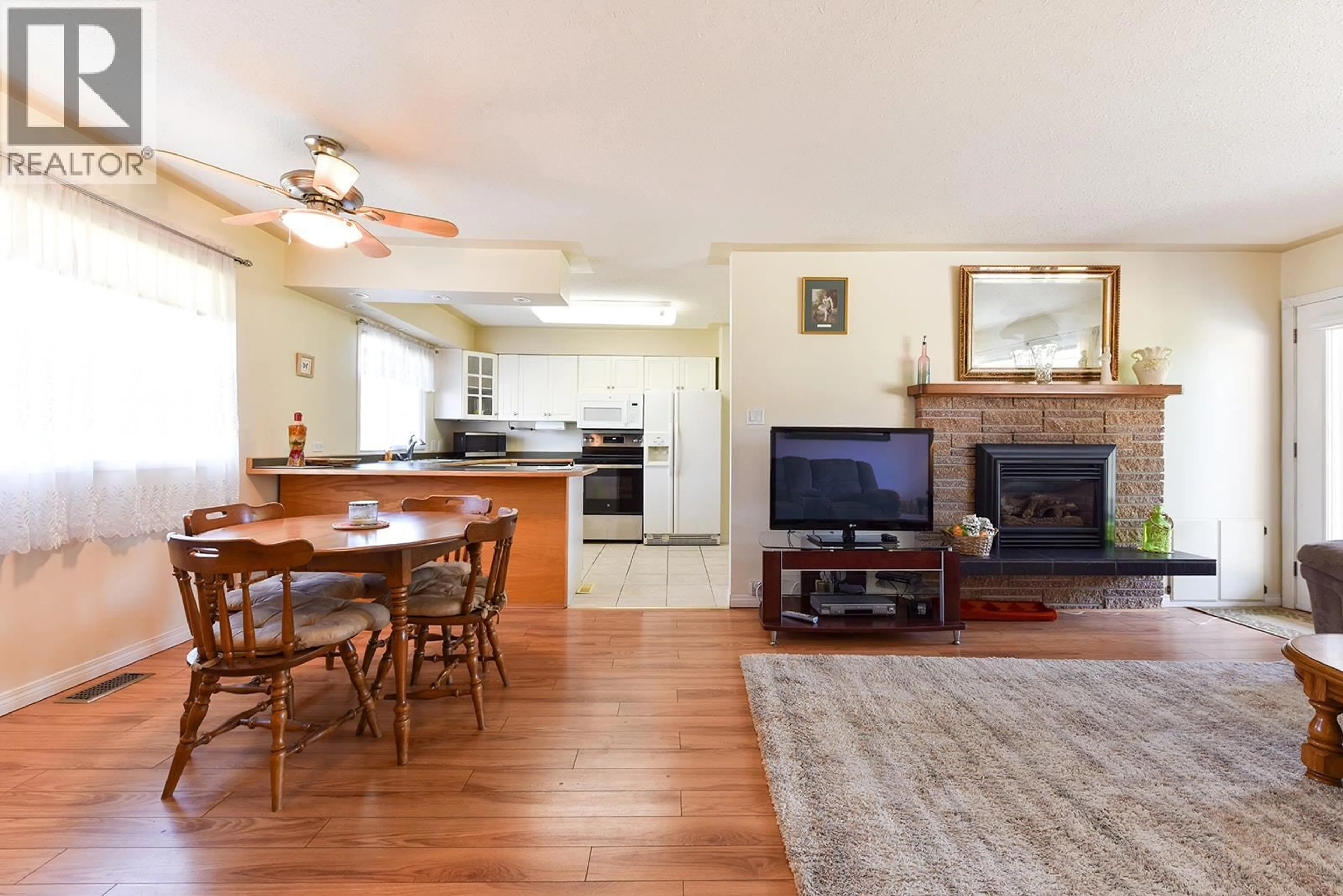 Open concept kitchen, wood/laminate floor for 52 GRANBY PLACE, Penticton British Columbia V2A2Z4