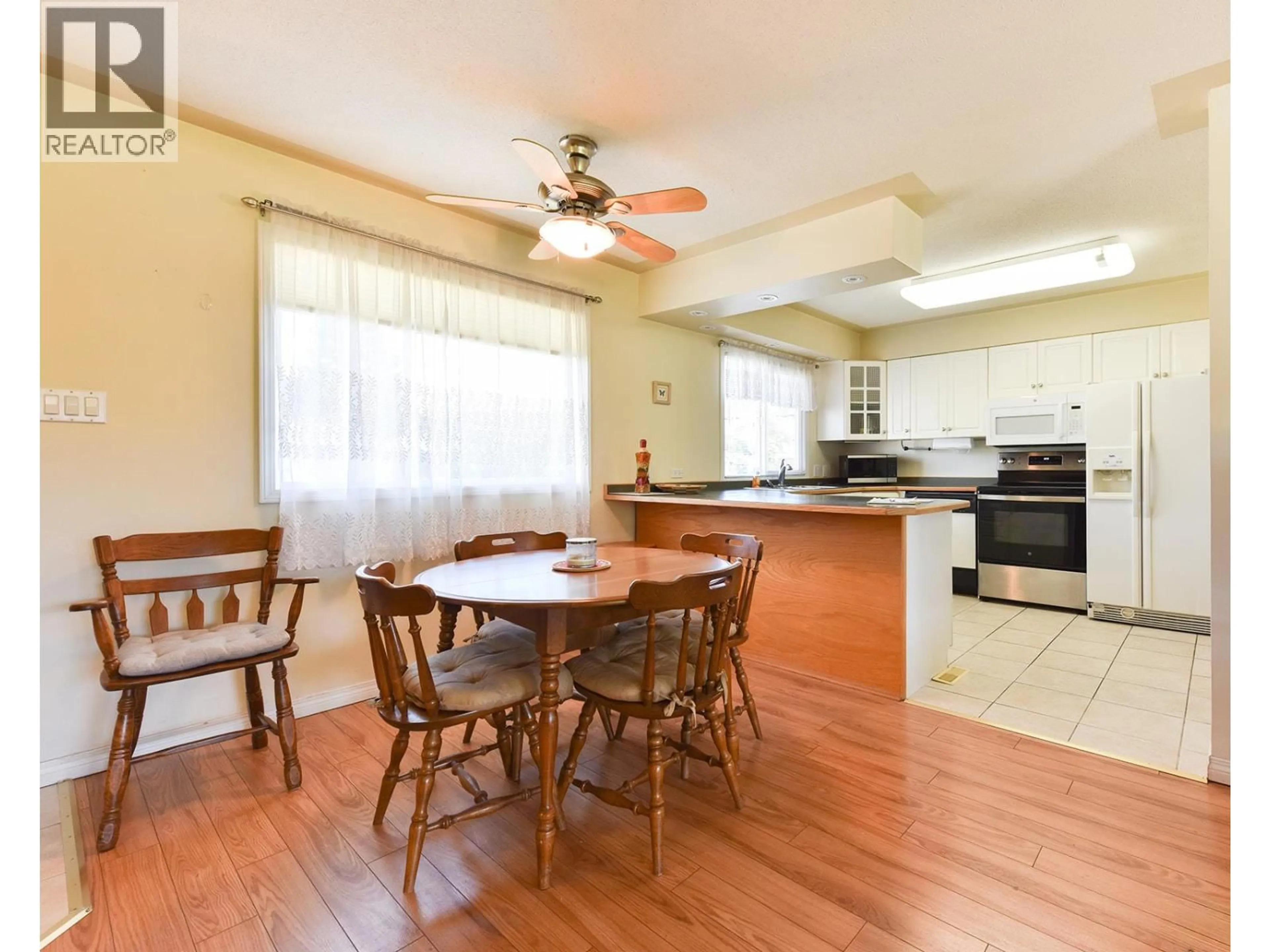 Open concept kitchen, wood/laminate floor for 52 GRANBY PLACE, Penticton British Columbia V2A2Z4