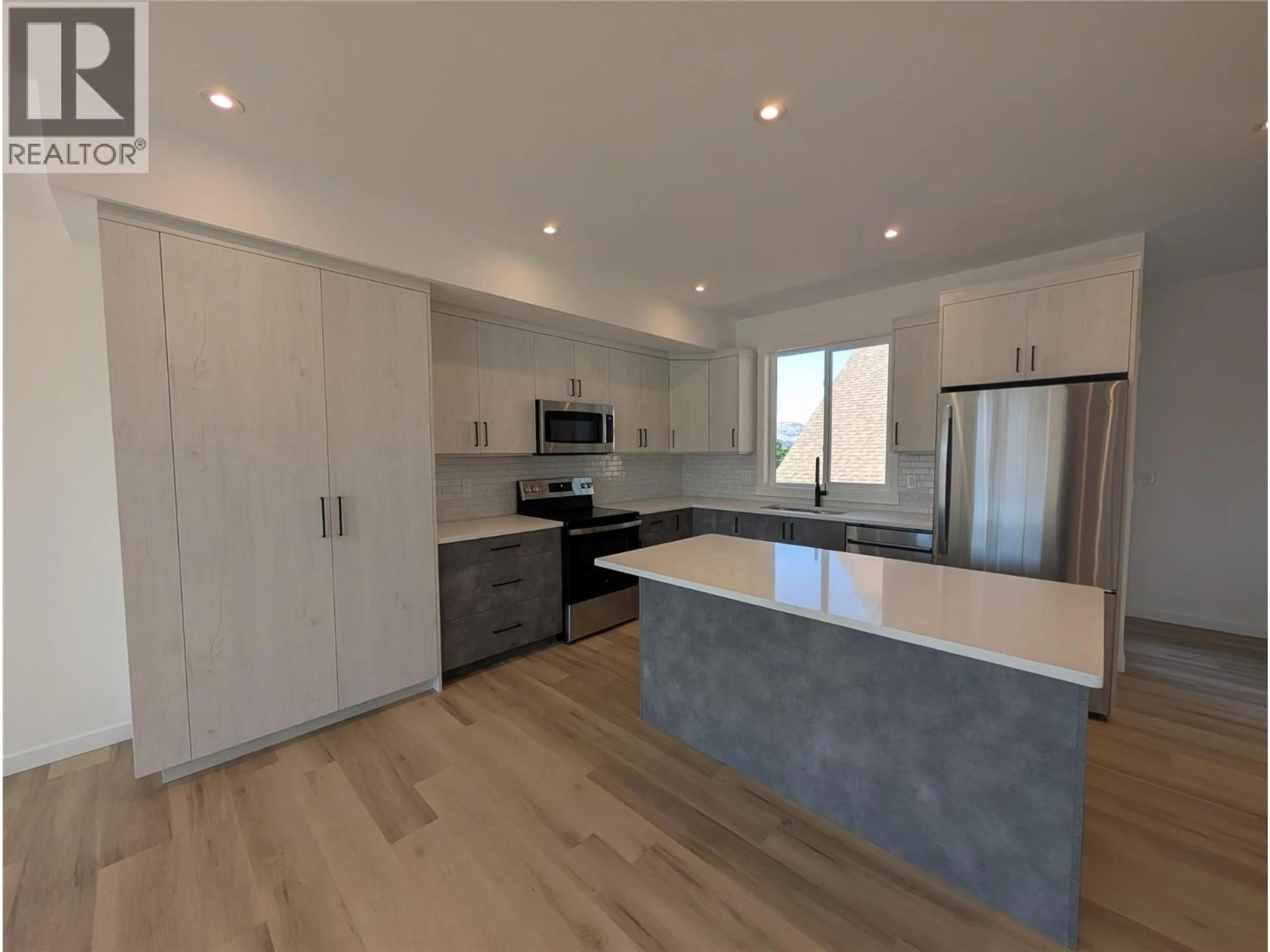 Open concept kitchen, wood/laminate floor for 3 - 3602 PLEASANT VALLEY ROAD, Vernon British Columbia V1T4L6