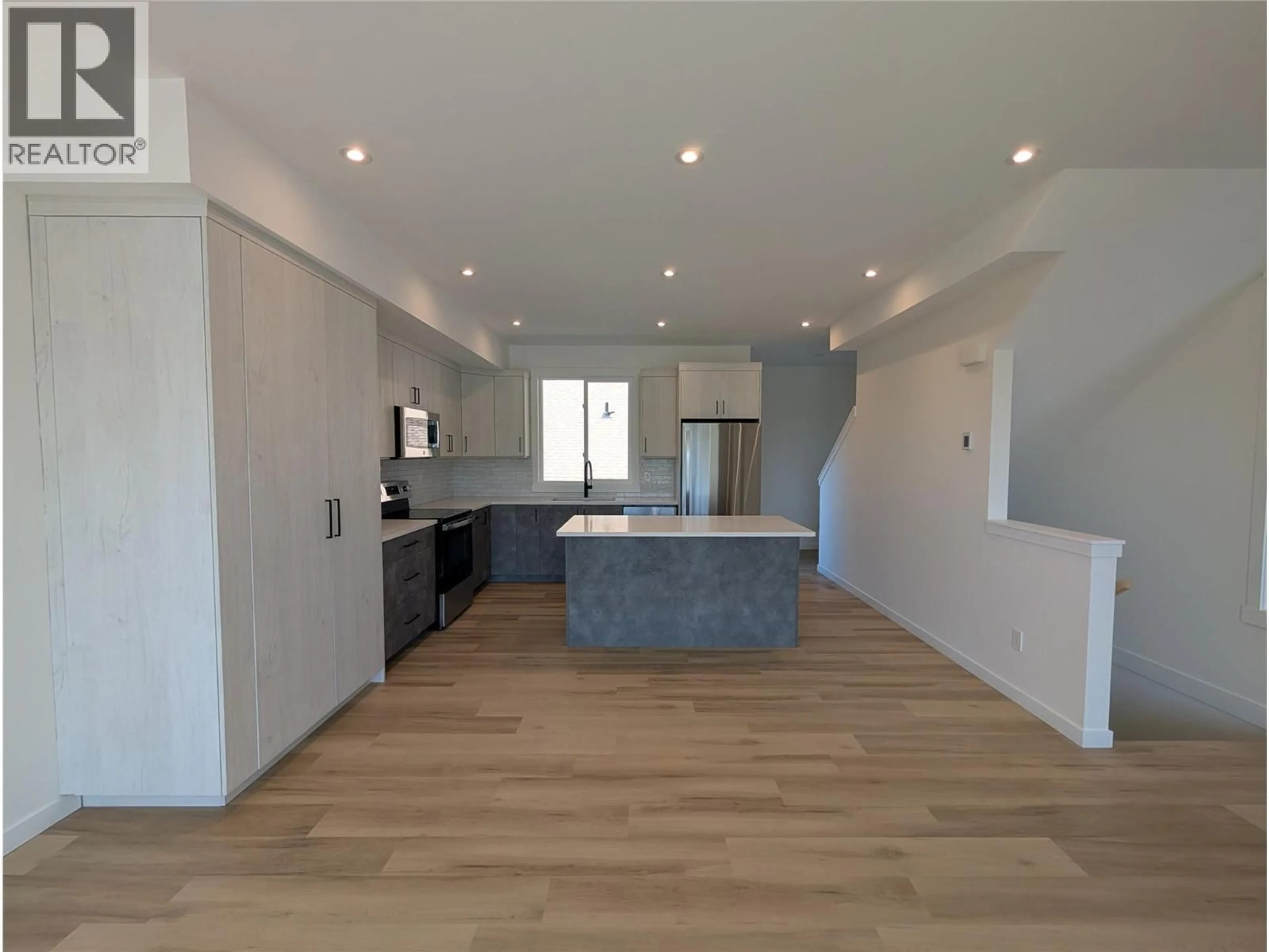 Open concept kitchen, wood/laminate floor for 3 - 3602 PLEASANT VALLEY ROAD, Vernon British Columbia V1T4L6