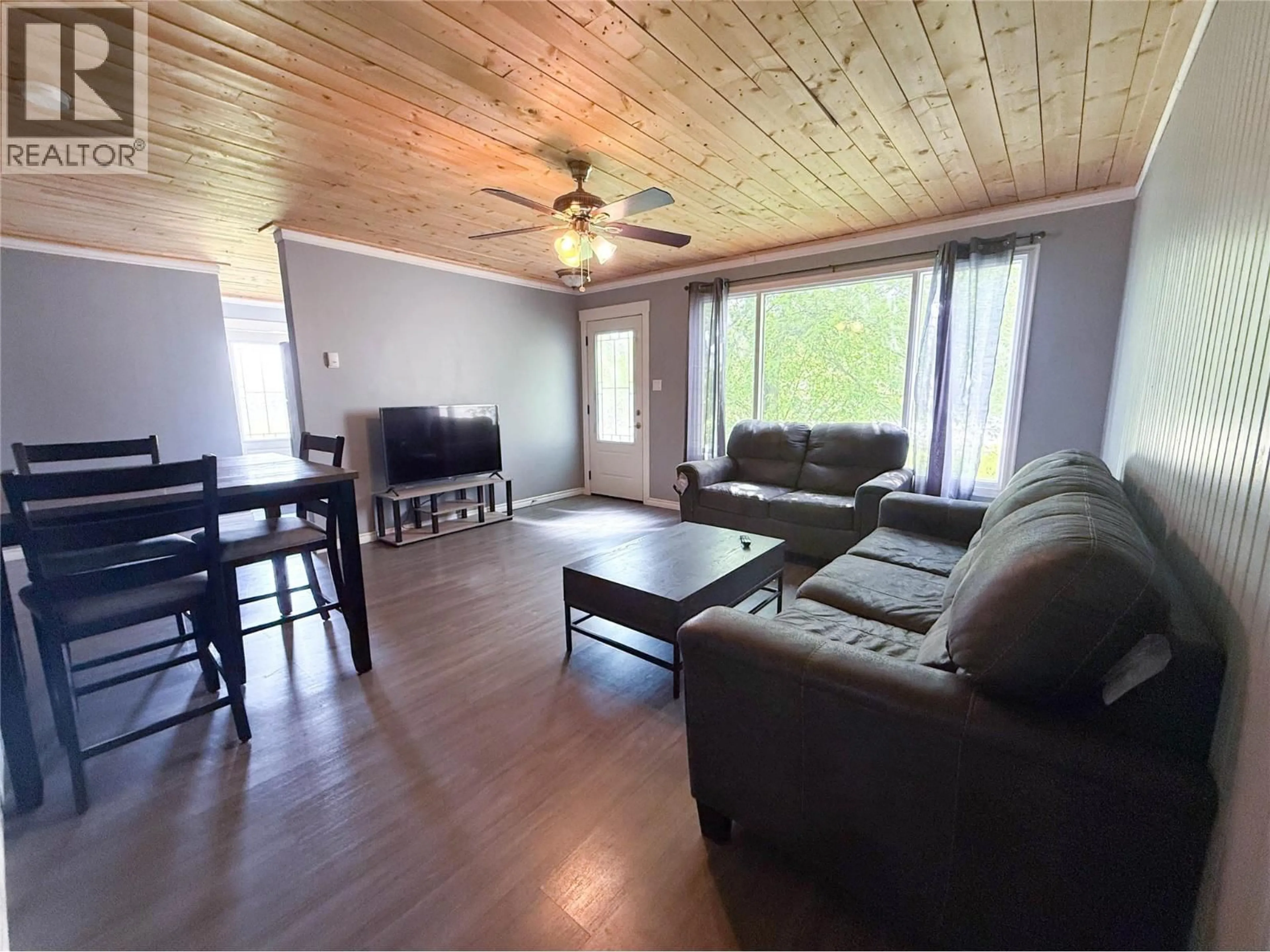Living room with furniture, wood/laminate floor for 5024 49 AVENUE NORTHWEST, Chetwynd British Columbia V0C1J0