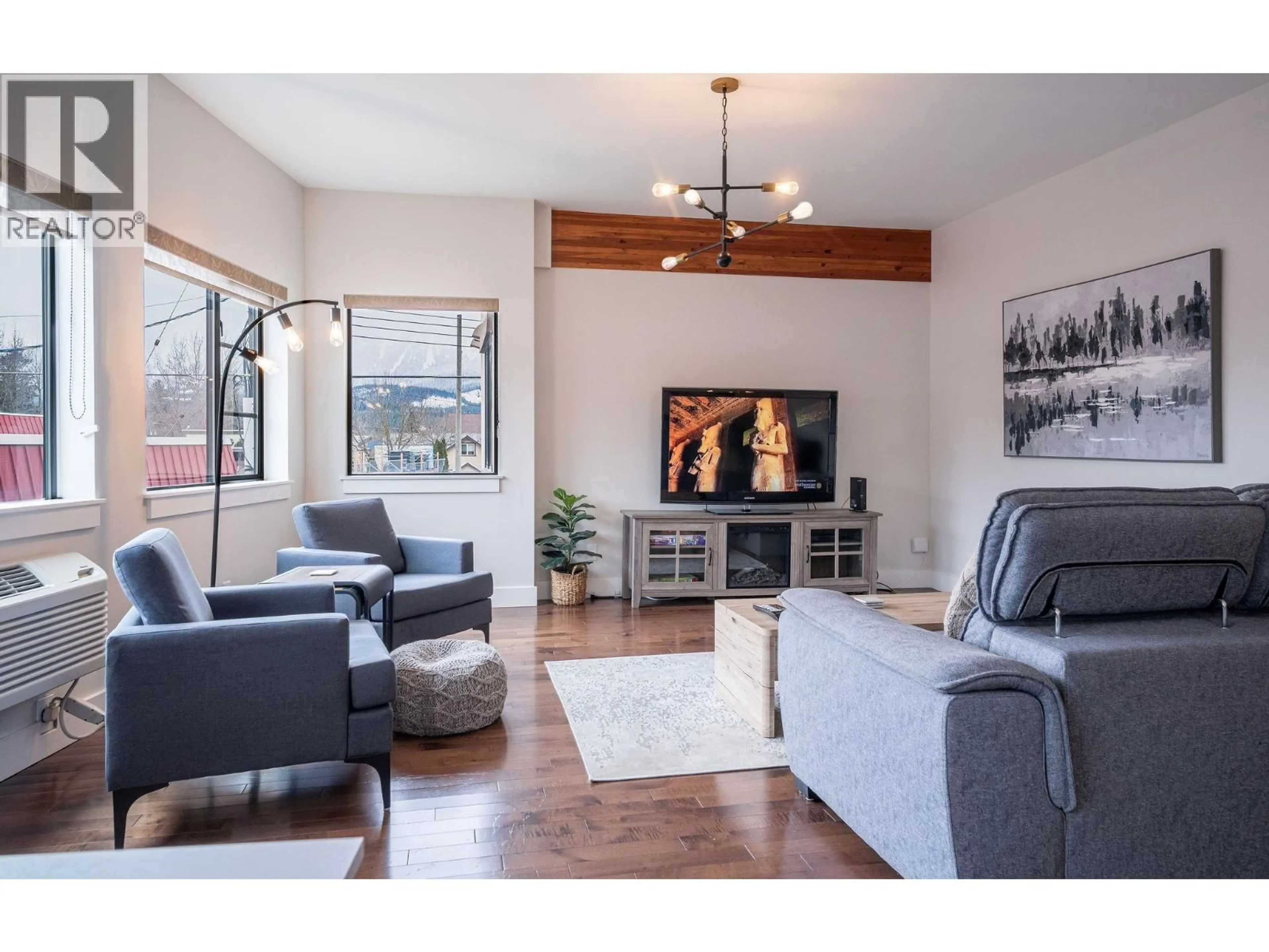 Living room with furniture, wood/laminate floor for 203 - 309 FIRST STREET WEST, Revelstoke British Columbia V0E2S0