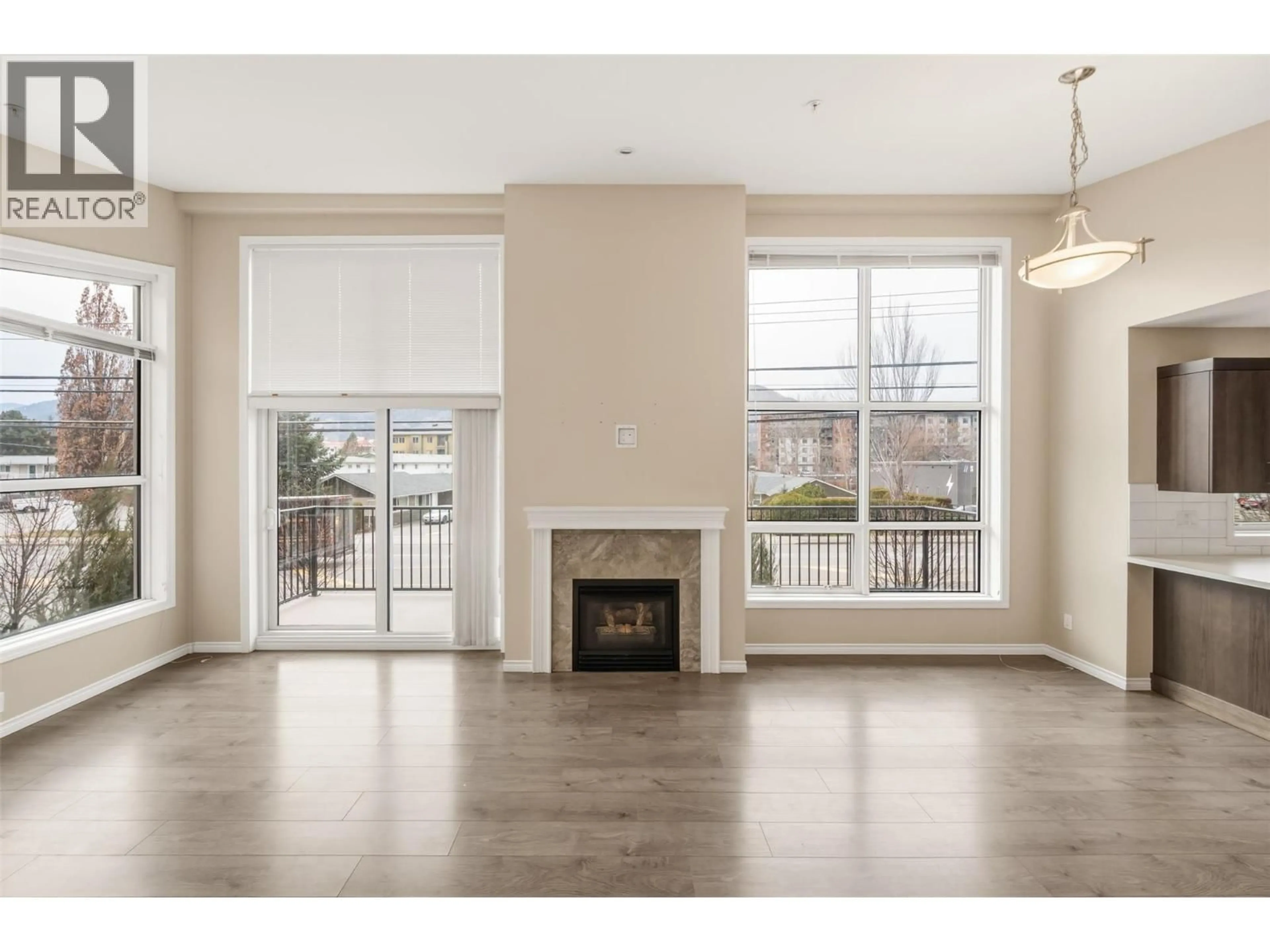 Living room with furniture, wood/laminate floor for 201 - 3388 SKAHA LAKE ROAD, Penticton British Columbia V2A6G4