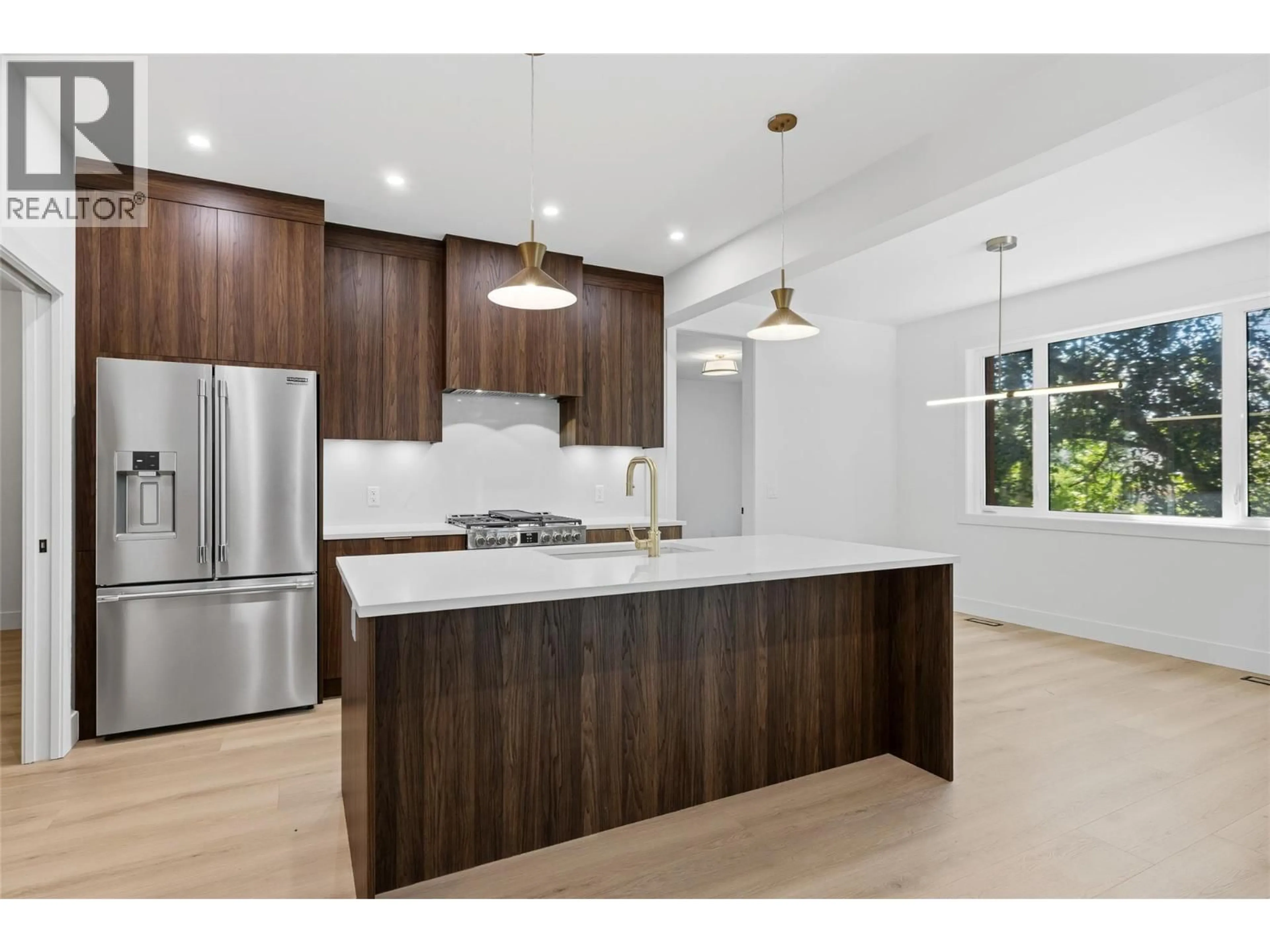 Open concept kitchen, wood/laminate floor for 4222 RUSSO STREET, Kelowna British Columbia V1W0C6